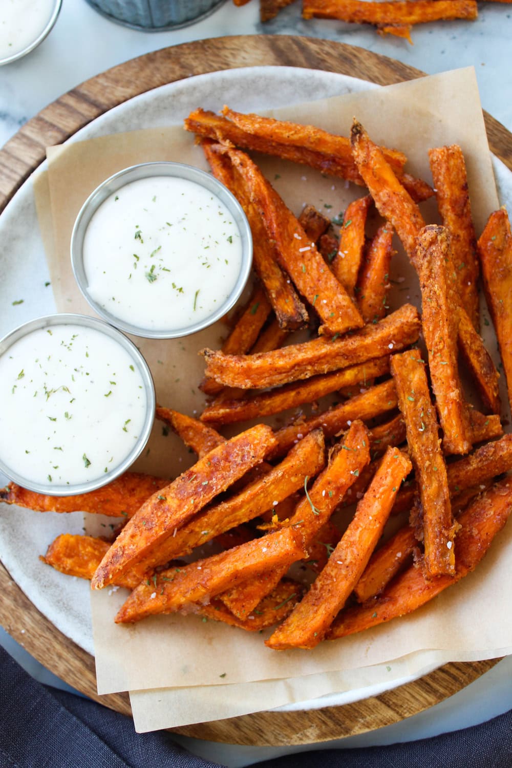Crispy oven baked sweet potato fries, golden brown and seasoned, served on a plate