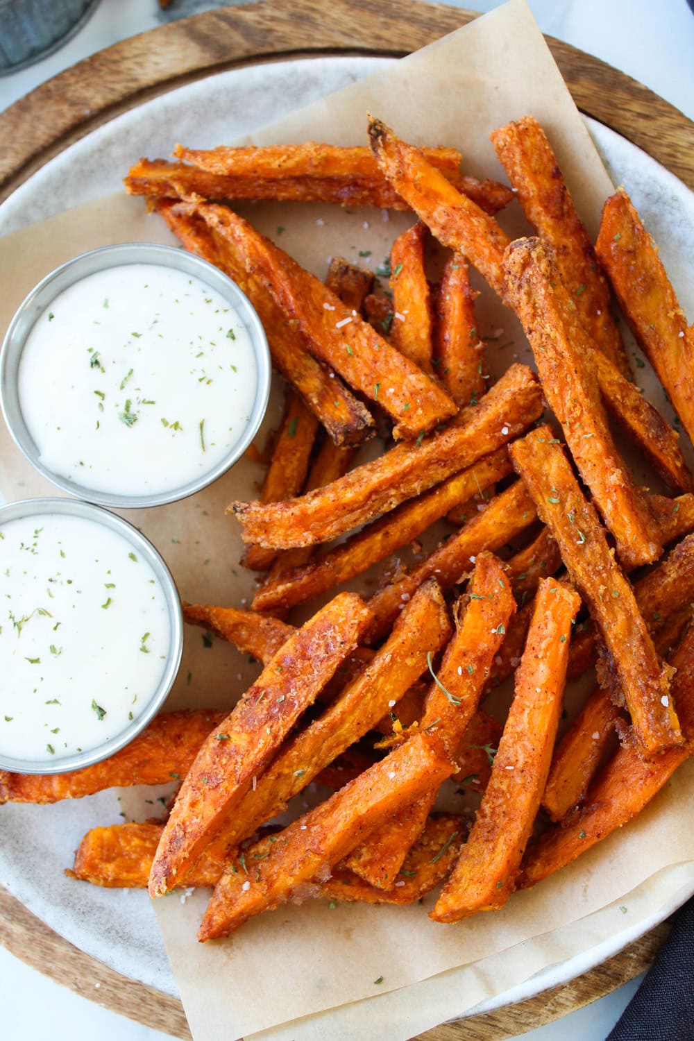 Crispy oven baked sweet potato fries served with a small bowl of dipping sauce