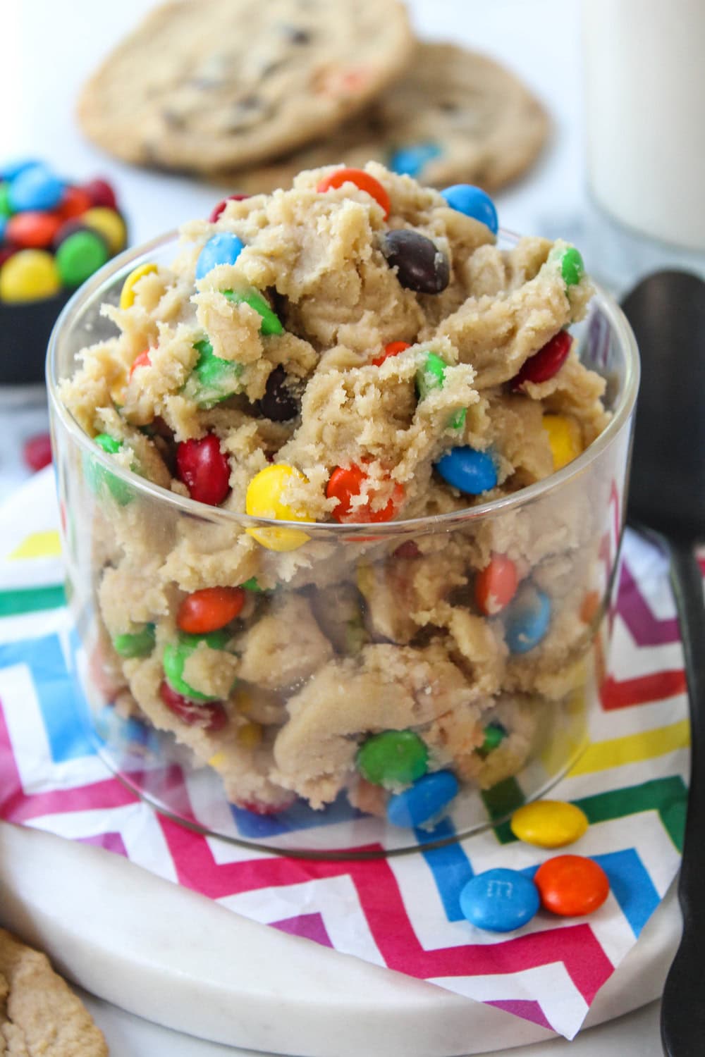Creamy edible M&M cookie dough with colorful chocolate candies mixed throughout