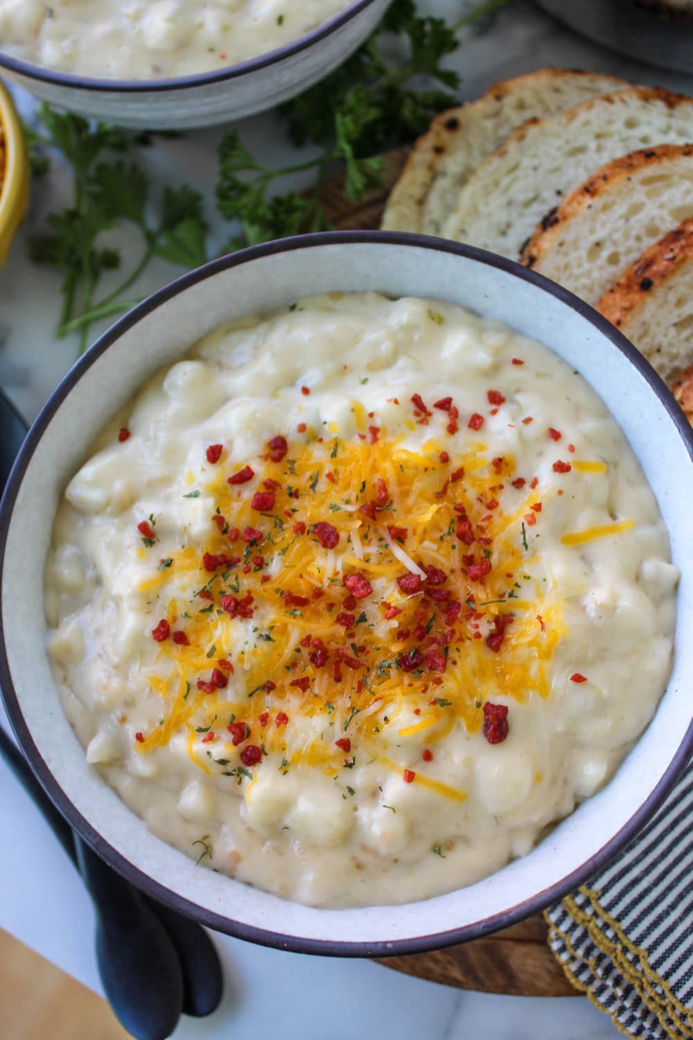 Easy cheesy potato soup served with crusty bread on the side