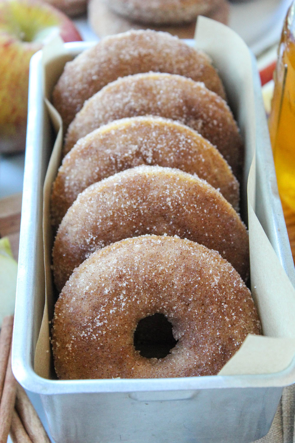 Homemade baked apple cider donuts dusted with cinnamon sugar, showing a soft cake-like texture