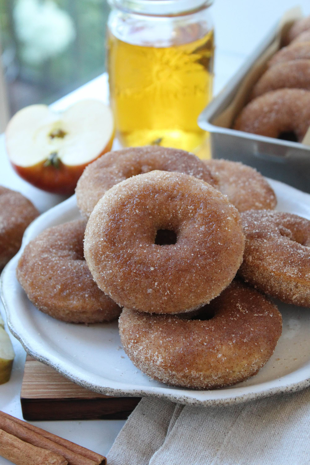 Close-up of baked apple cider donuts with a crisp cinnamon-sugar exterior and tender interior