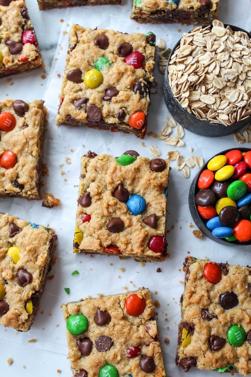Freshly baked monster cookie bars cut into squares with visible oats and melted chocolate