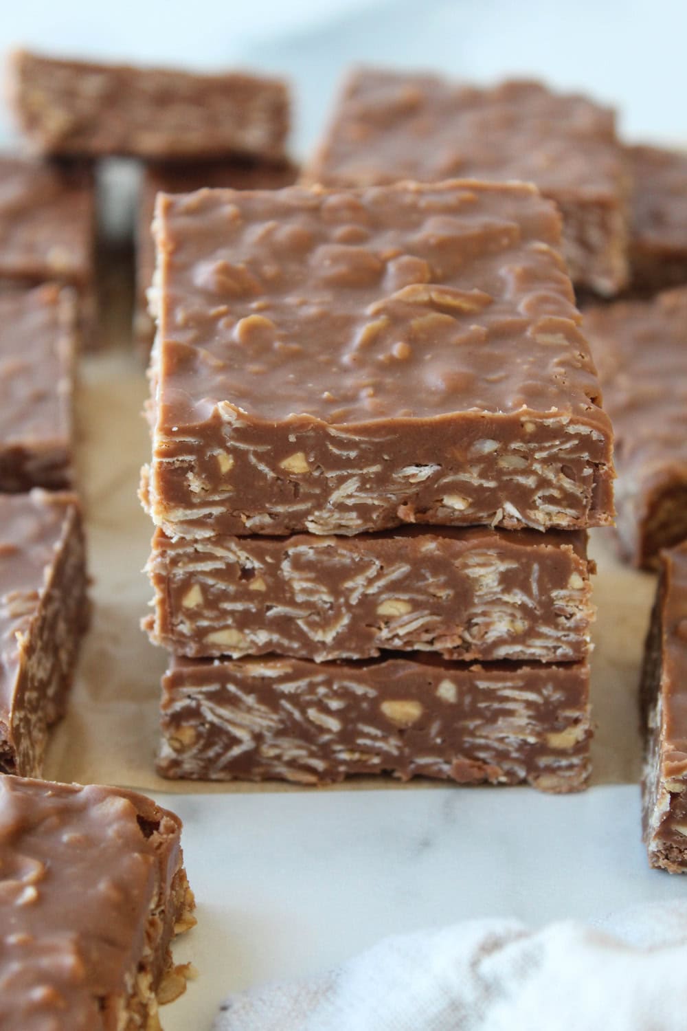 Close‑up of no‑bake chocolate peanut butter oat bars with a rich chocolate layer