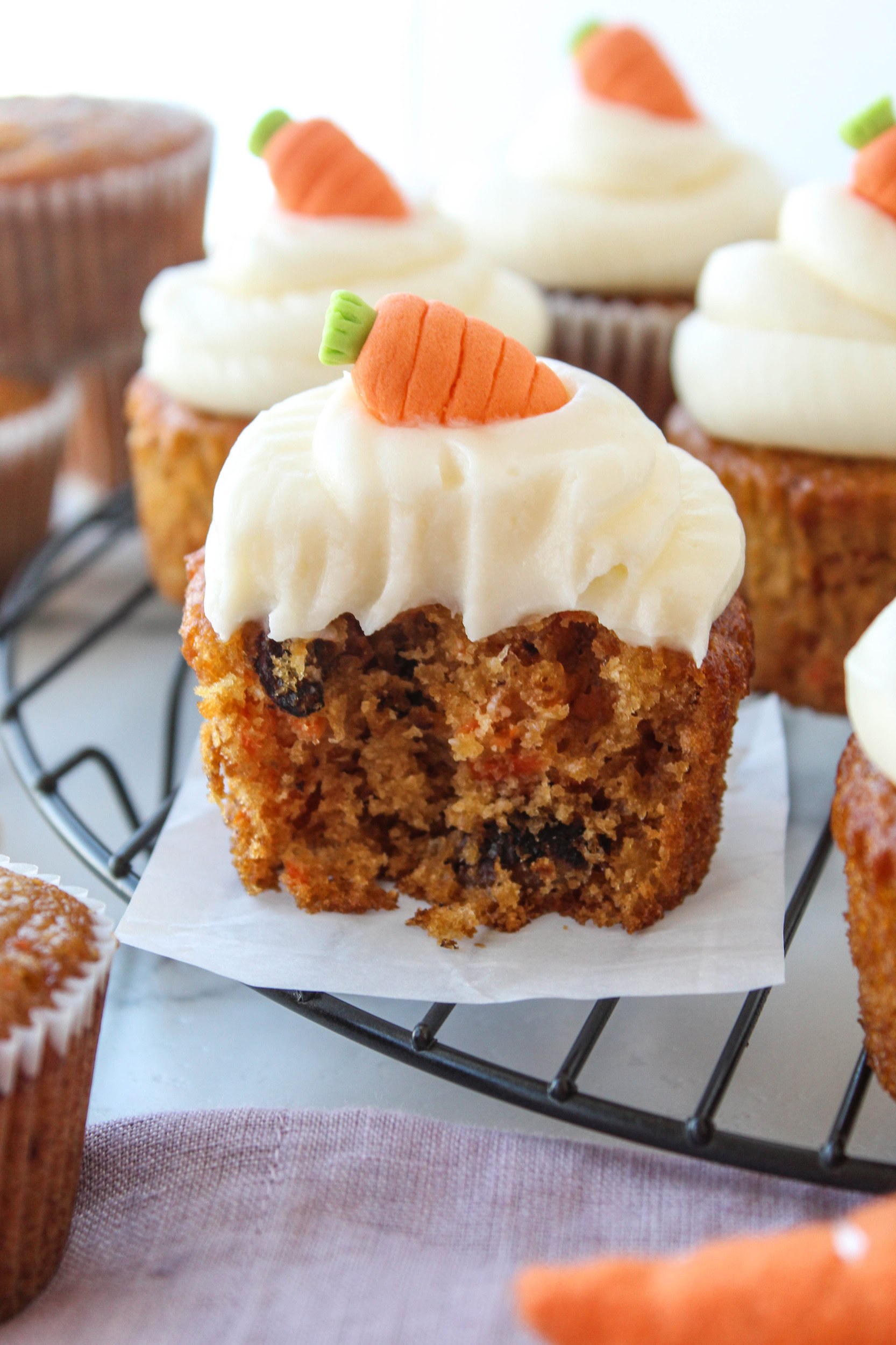 Carrot cake cupcakes with swirls of cream cheese frosting