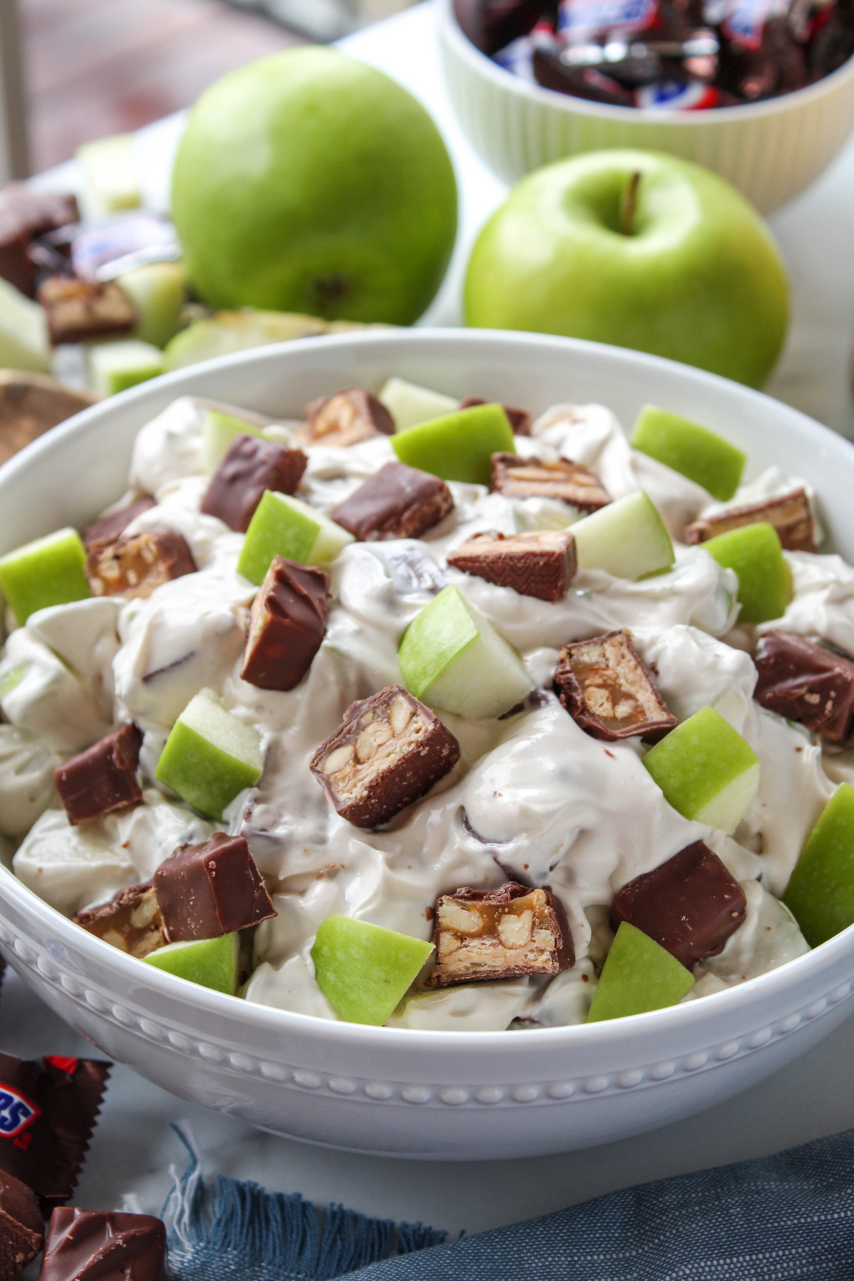 Sweet and creamy Snickers apple salad dessert with crisp apples and chewy candy bar pieces