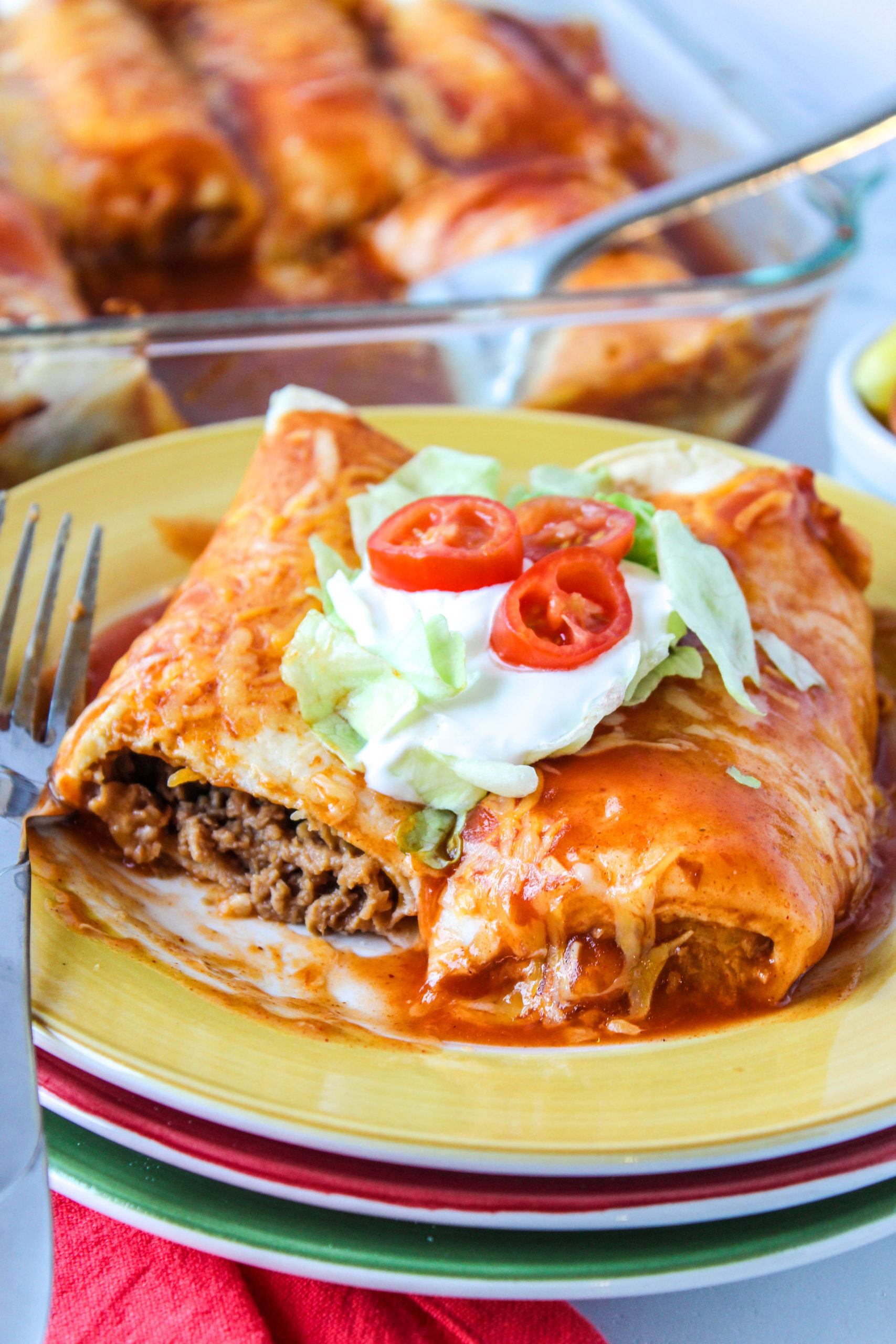 Cheesy vegetarian enchilada topped with enchilada sauce