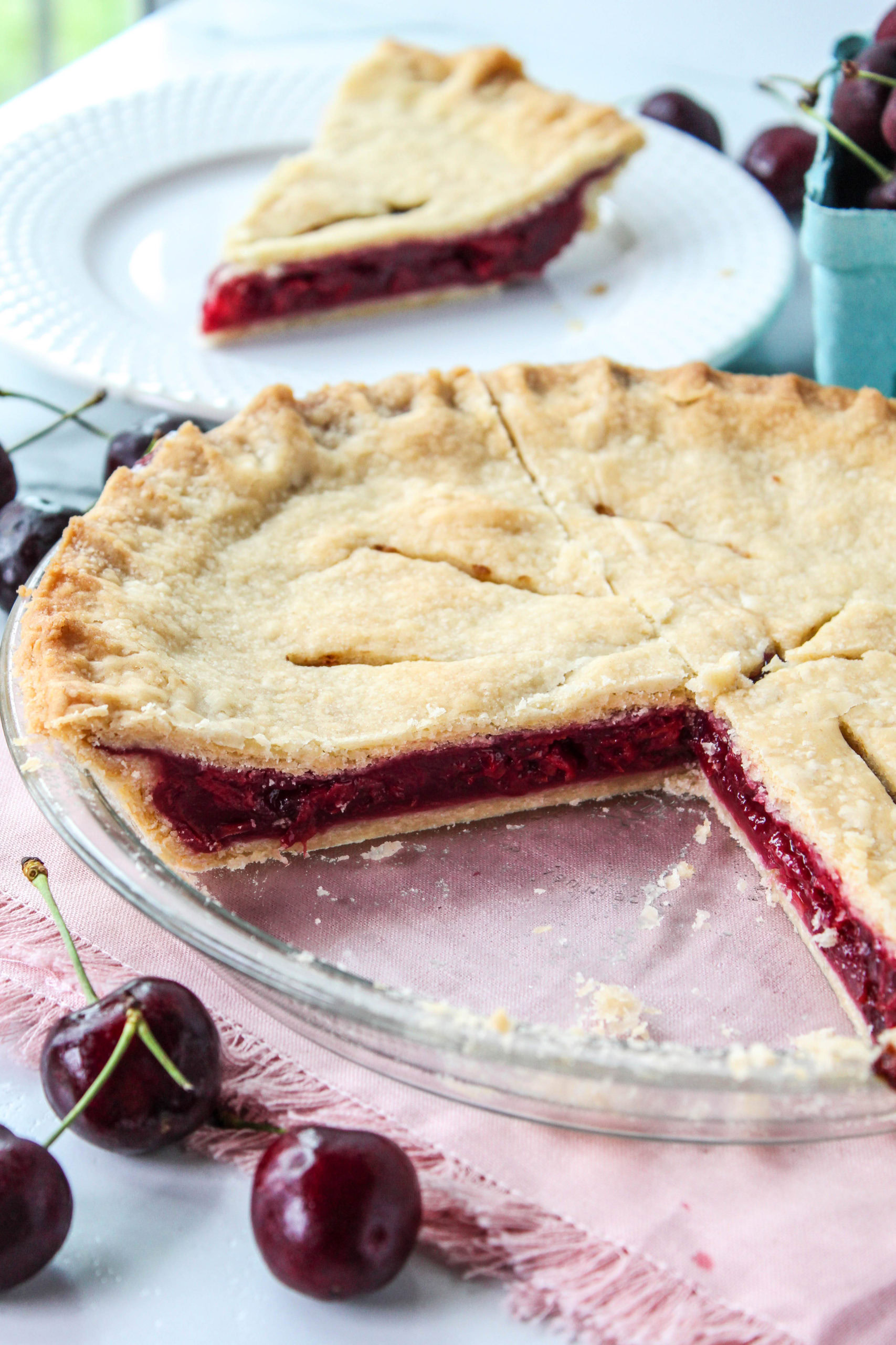 Homemade cherry pie dessert served with flaky crust and glossy cherry filling