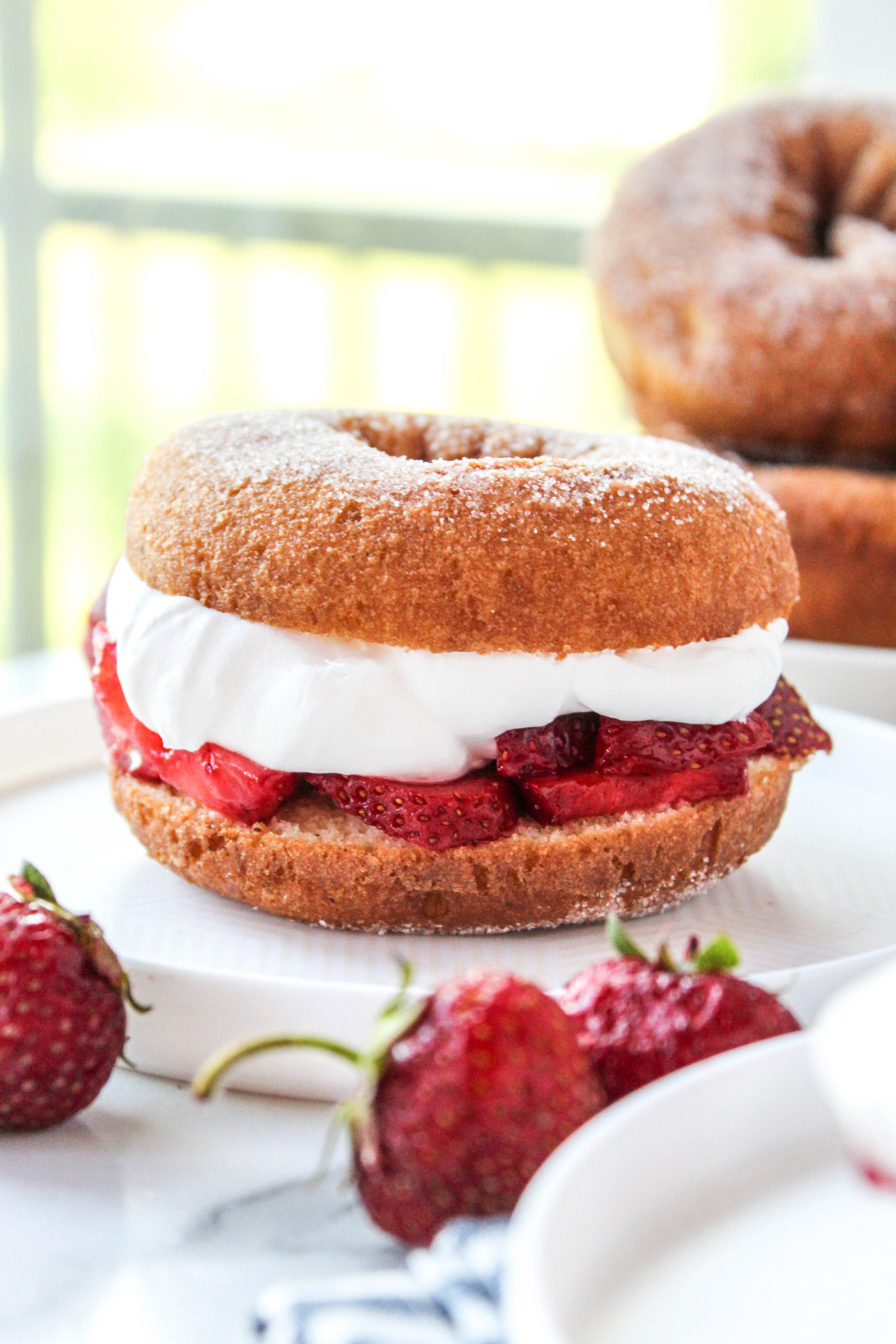 homemade strawberry shortcake with donuts and syrupy berries