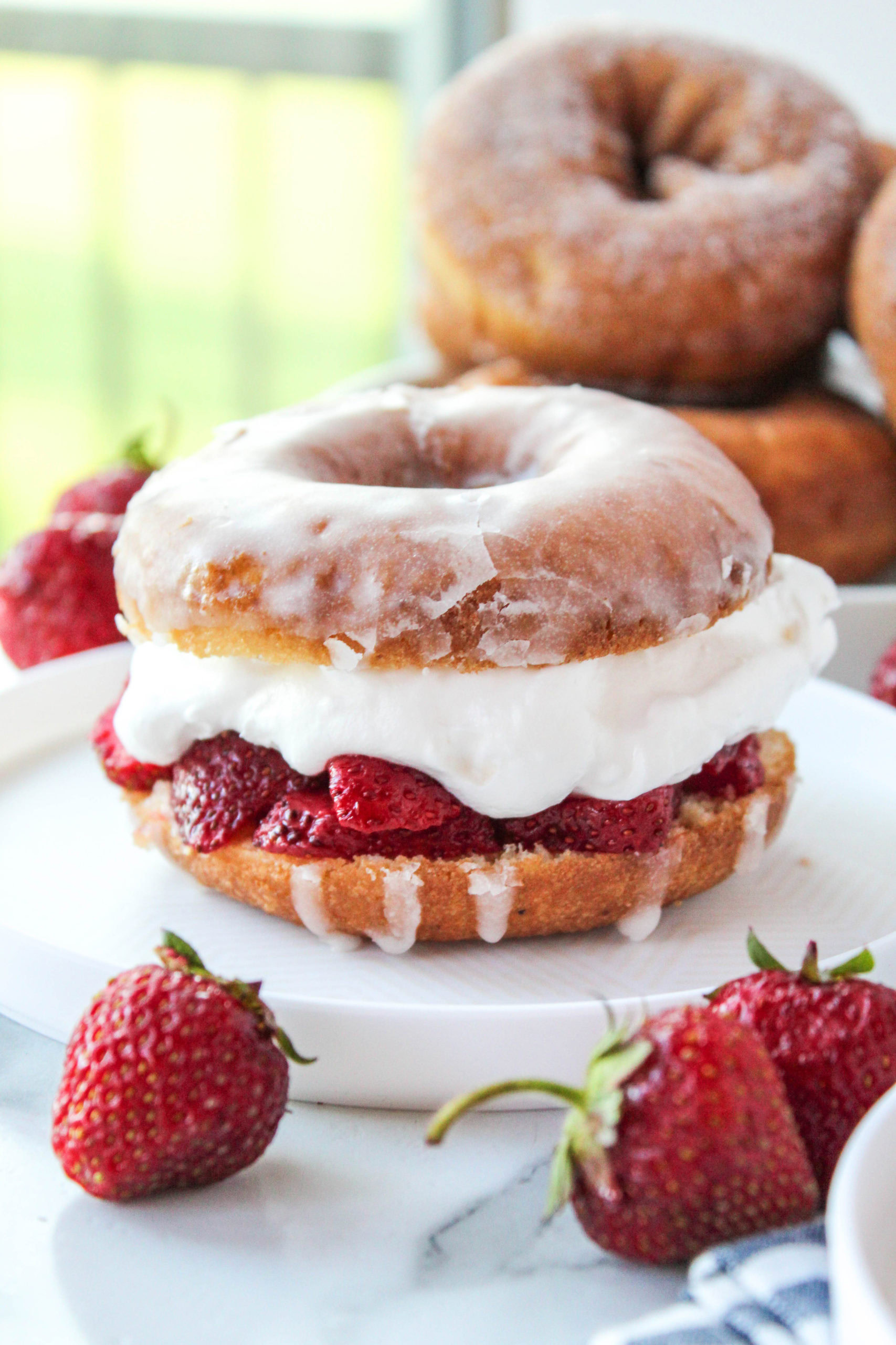 close up of strawberry shortcake using donuts and whipped cream