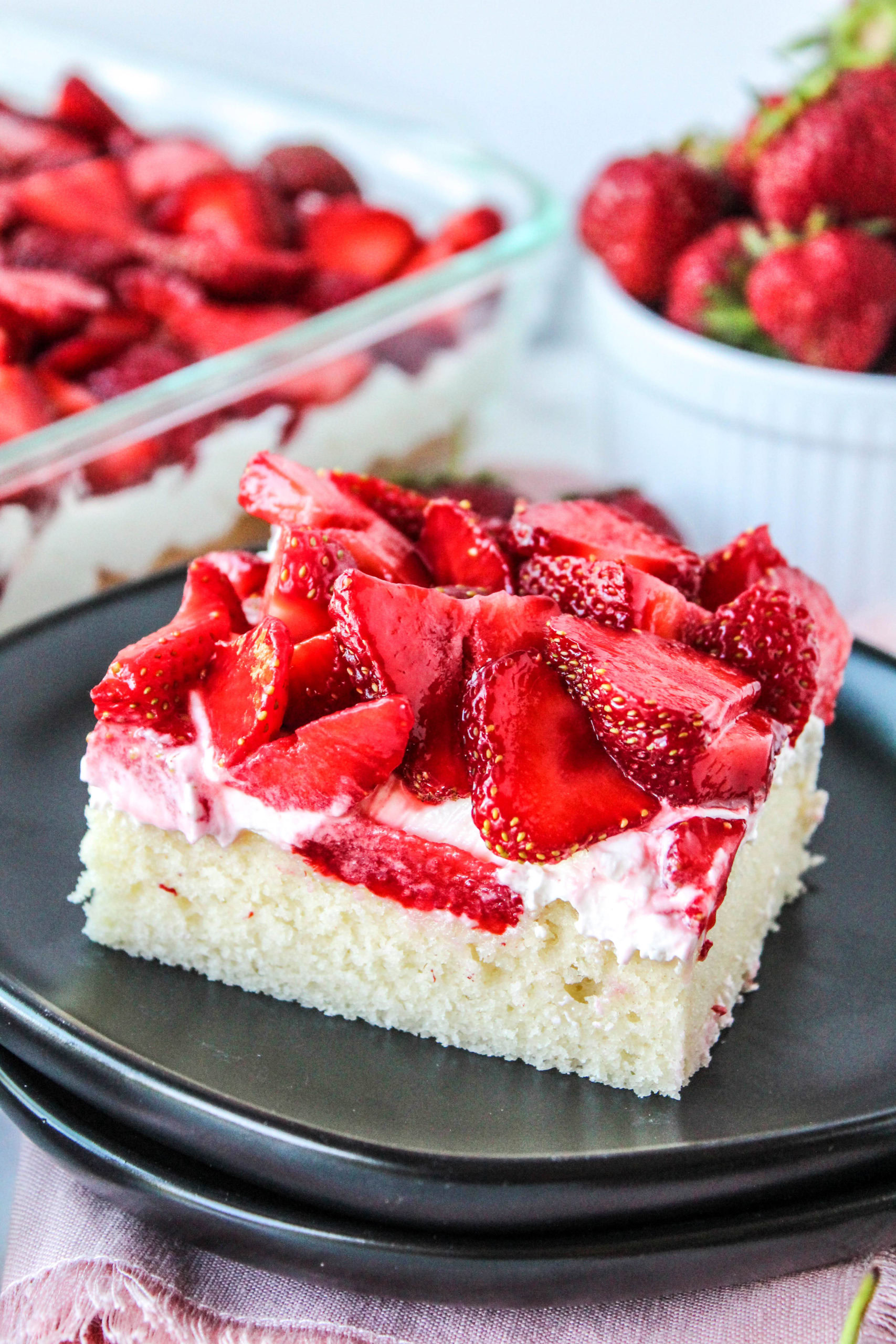 Strawberry shortcake bars sliced and served on a plate with fresh berries