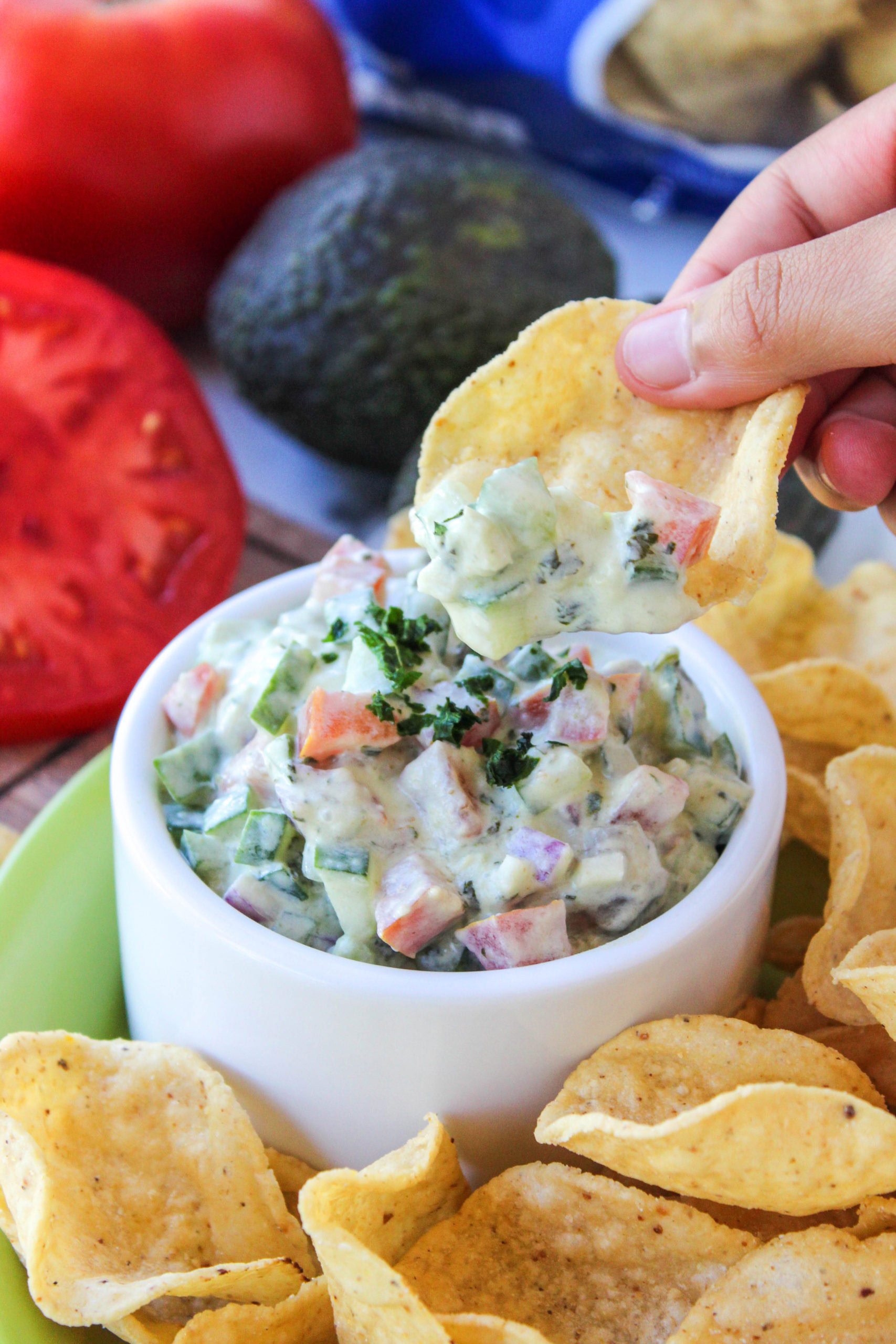 Healthy cucumber avocado salsa with tomatoes, red onion, lime, and garlic