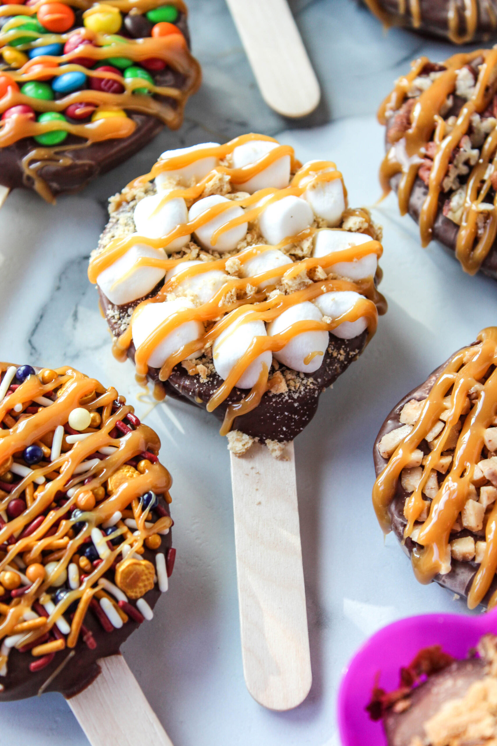 Handmade chocolate caramel apple pops with a glossy finish