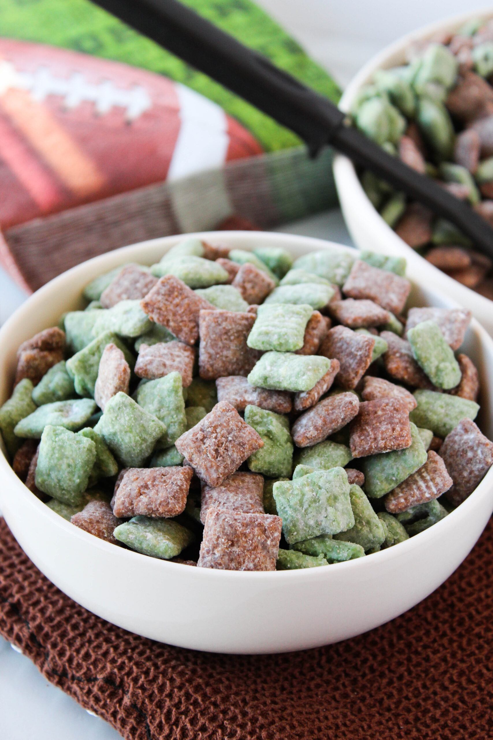 Football puppy chow in a serving tray with green game‑day napkins