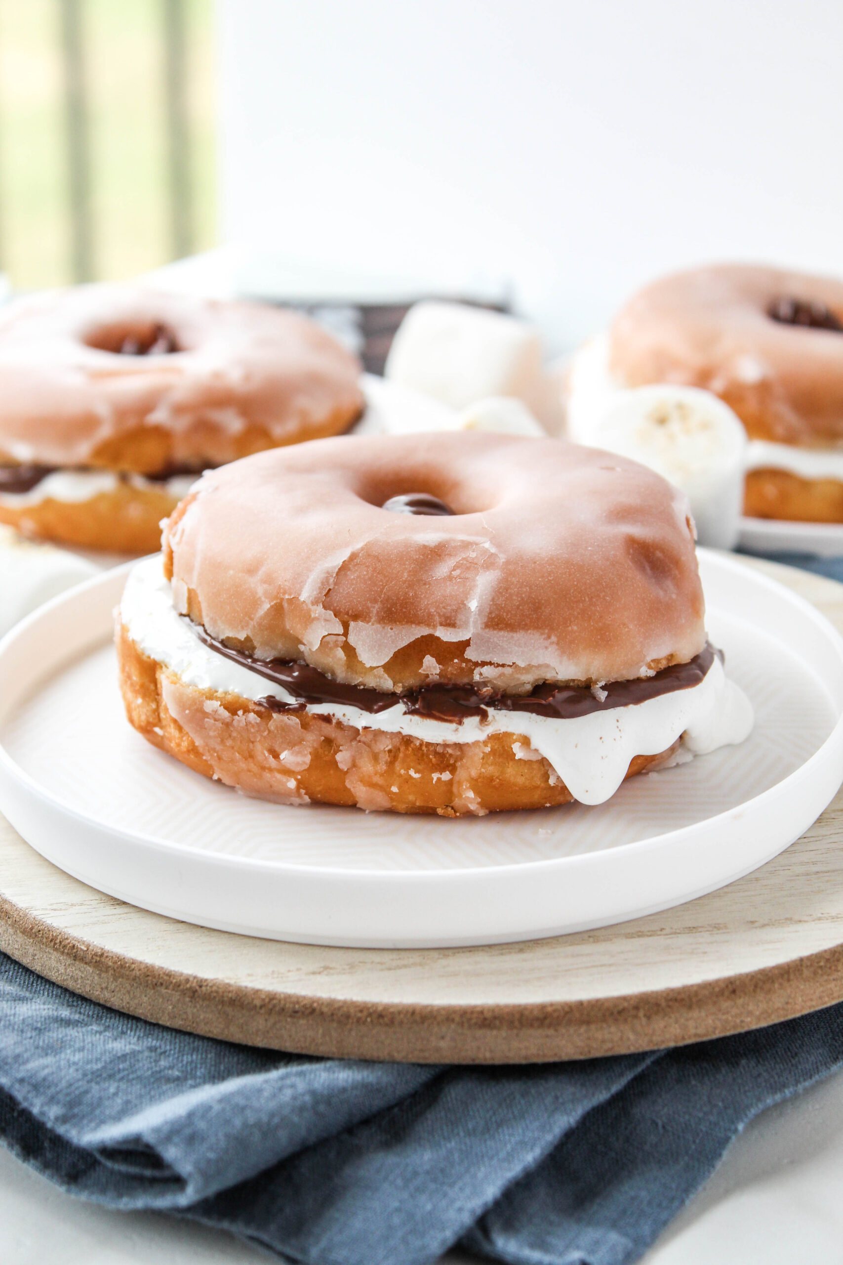 Easy donut s’mores made with glazed donuts, chocolate hazelnut spread, and marshmallow fluff