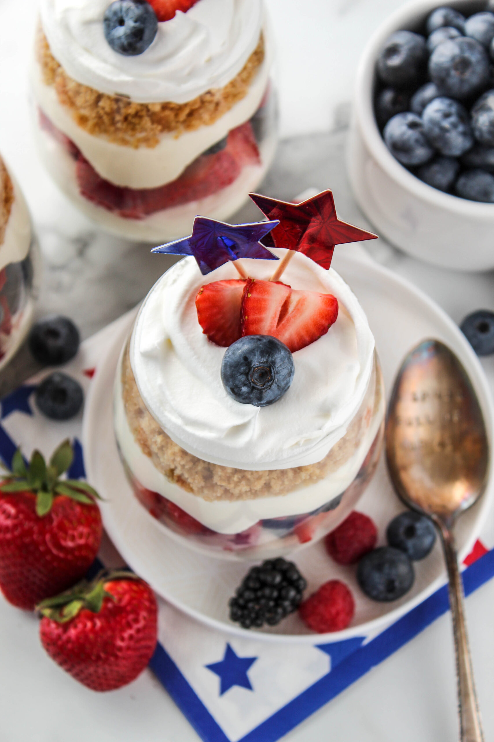 patriotic no bake cheesecake parfaits with strawberries blueberries and whipped cream