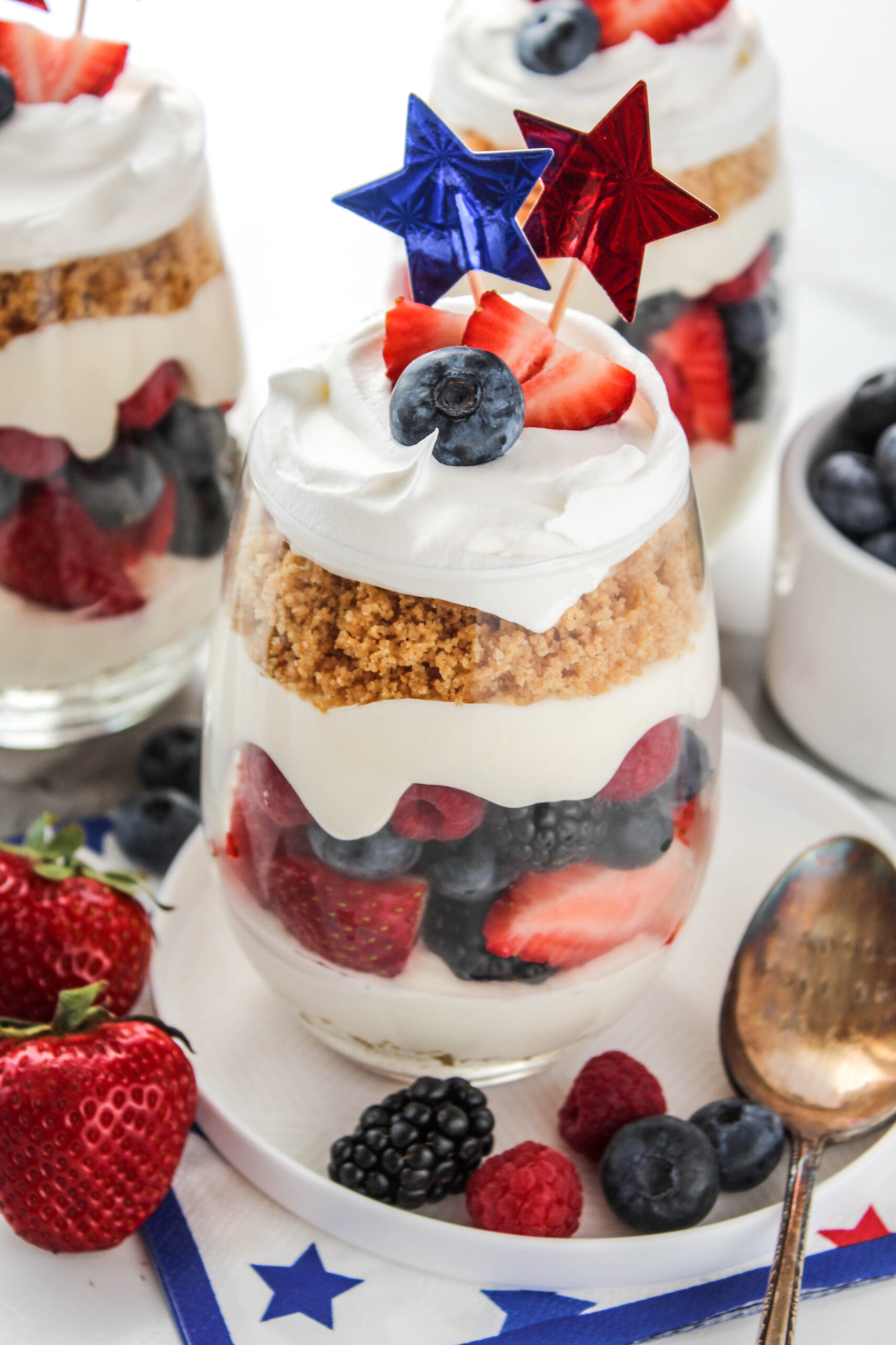 red white and blue cheesecake parfaits in glass cups