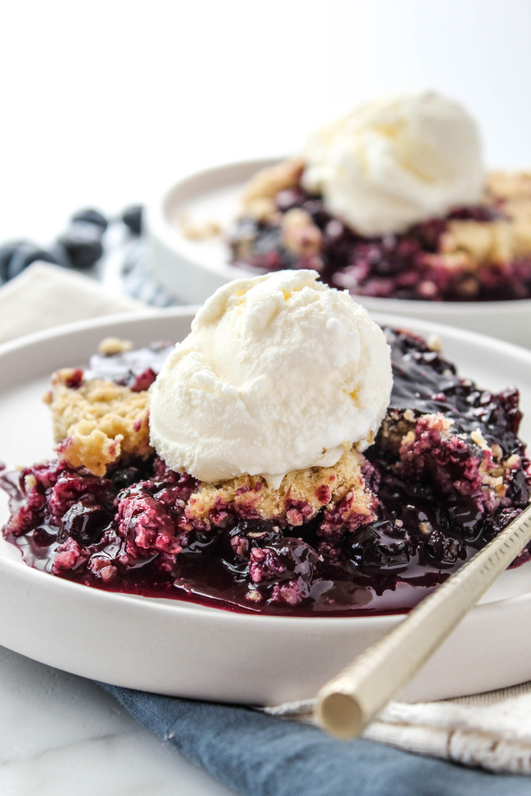 warm blueberry crisp with melting vanilla ice cream
