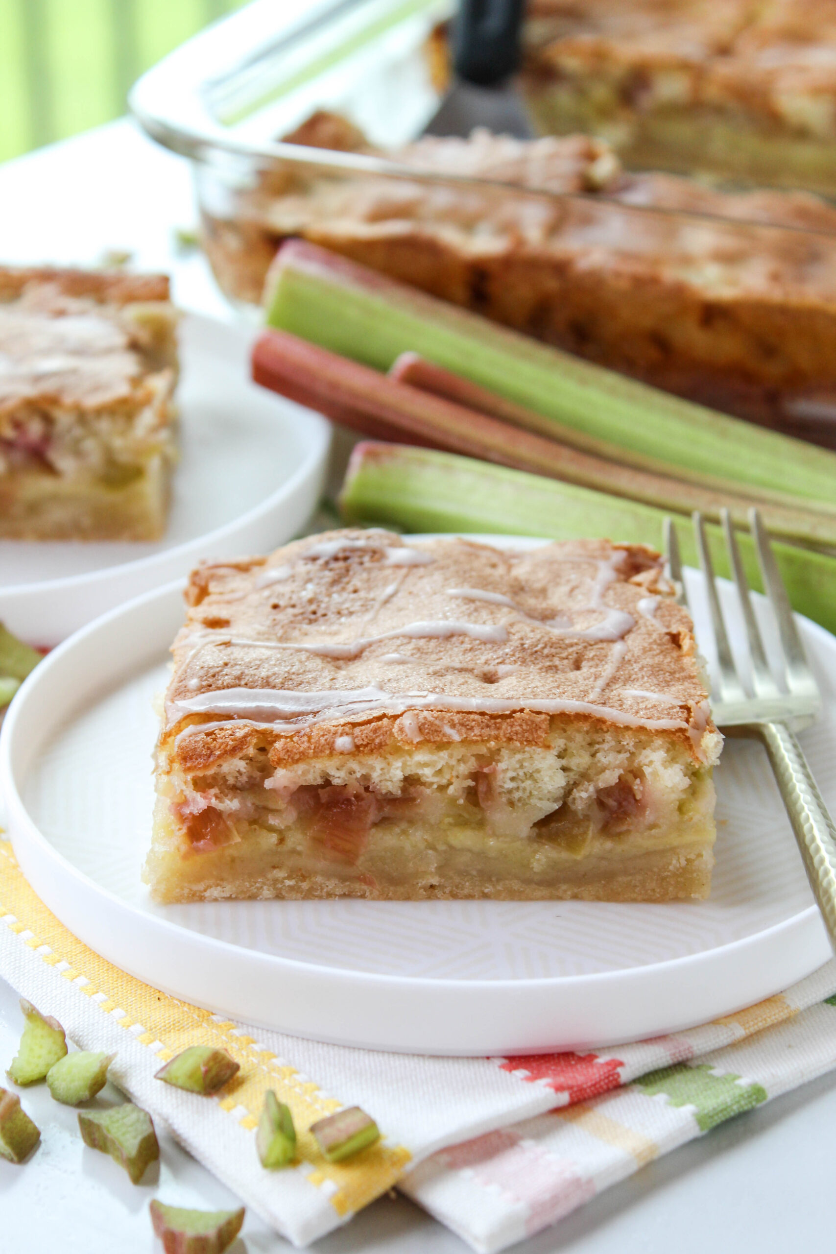 Close‑up of rhubarb dream bars showing shortbread crust and pink rhubarb filling