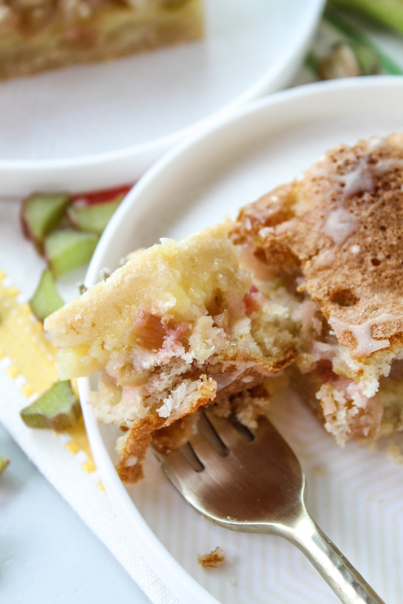 Sliced rhubarb dream bars served on a white plate