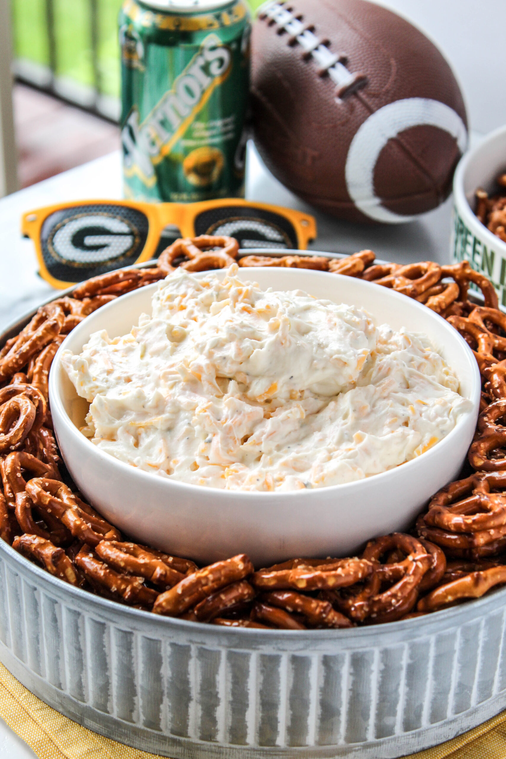 Creamy beer dip without beer served in a bowl with pretzels for dipping