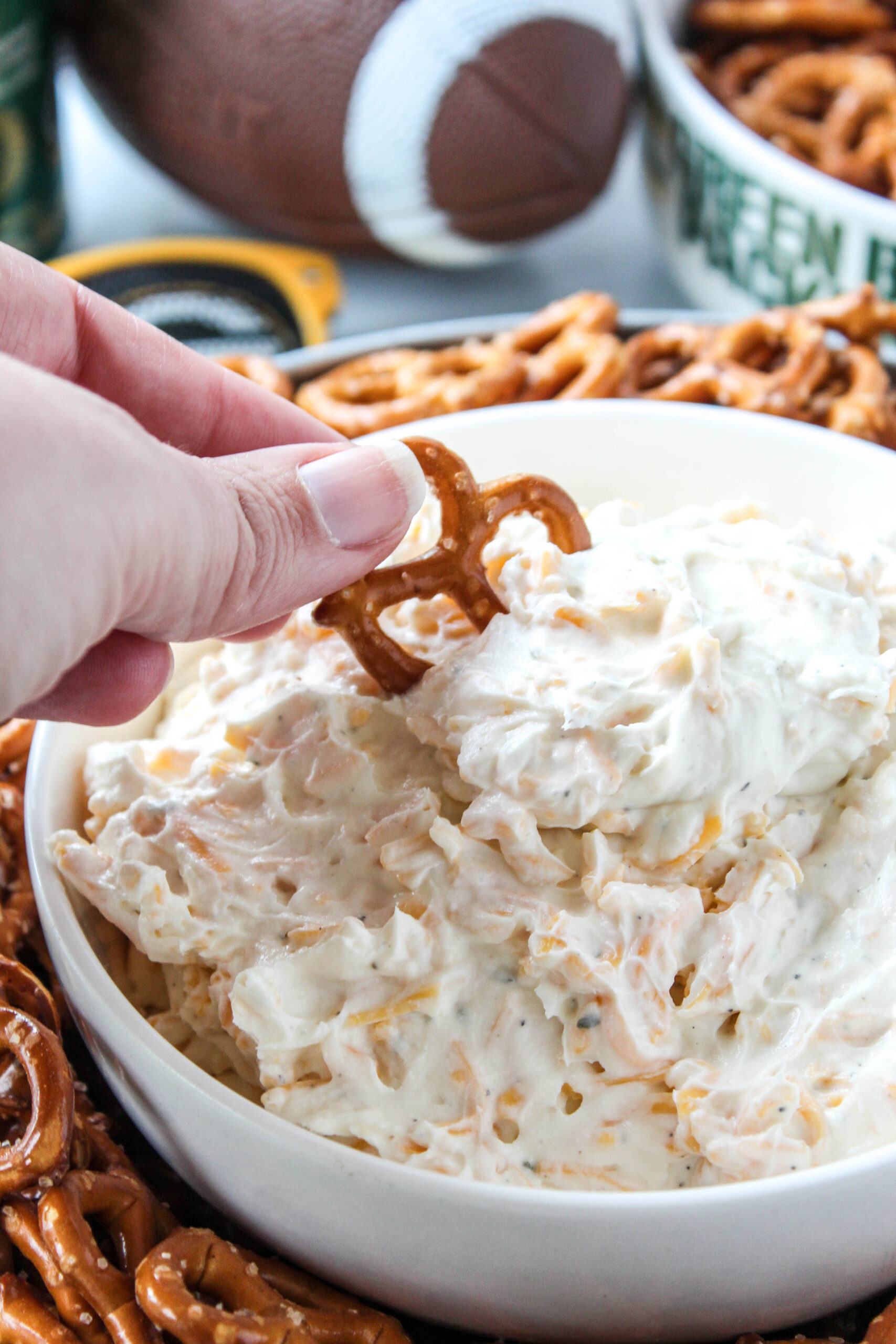 Creamy pub-style cheese dip without beer served alongside pretzel bites