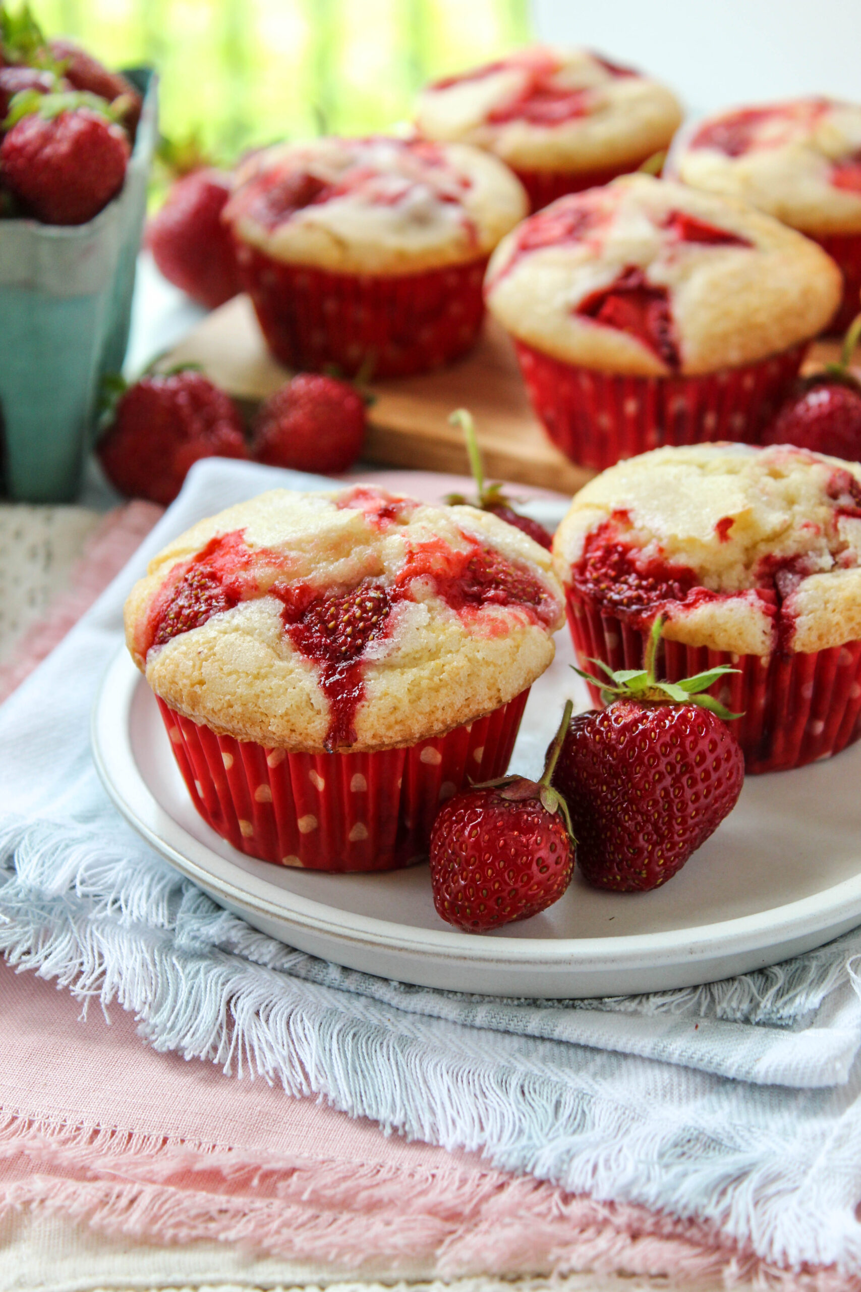 Soft strawberry muffins with golden domed tops and fresh berries