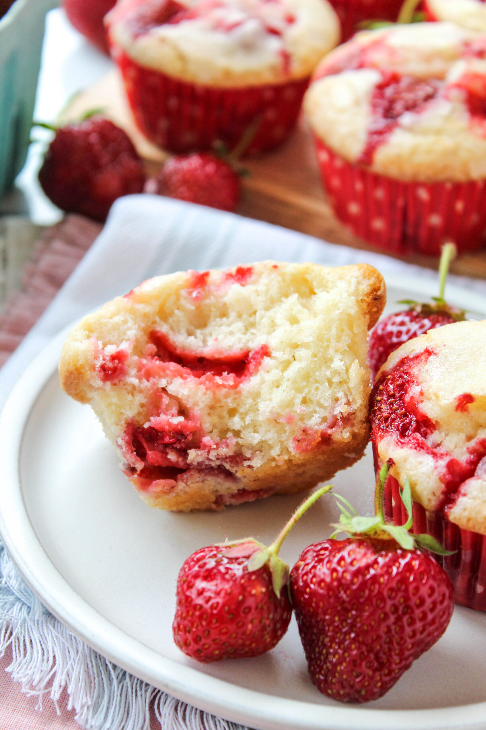 Strawberry muffin cut in half showing juicy strawberry pieces