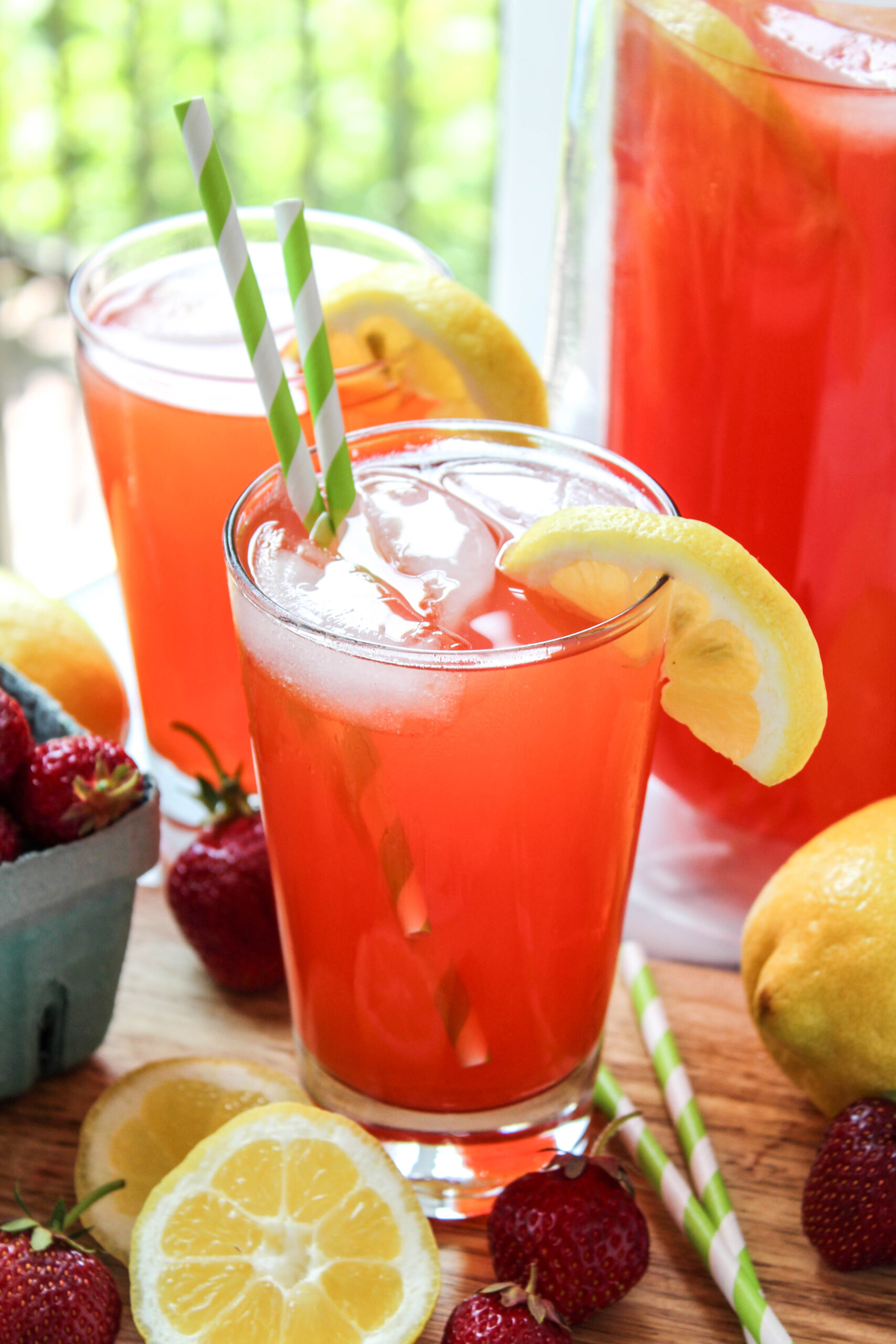 close up of strawberry lemonade with lemon slices and berries