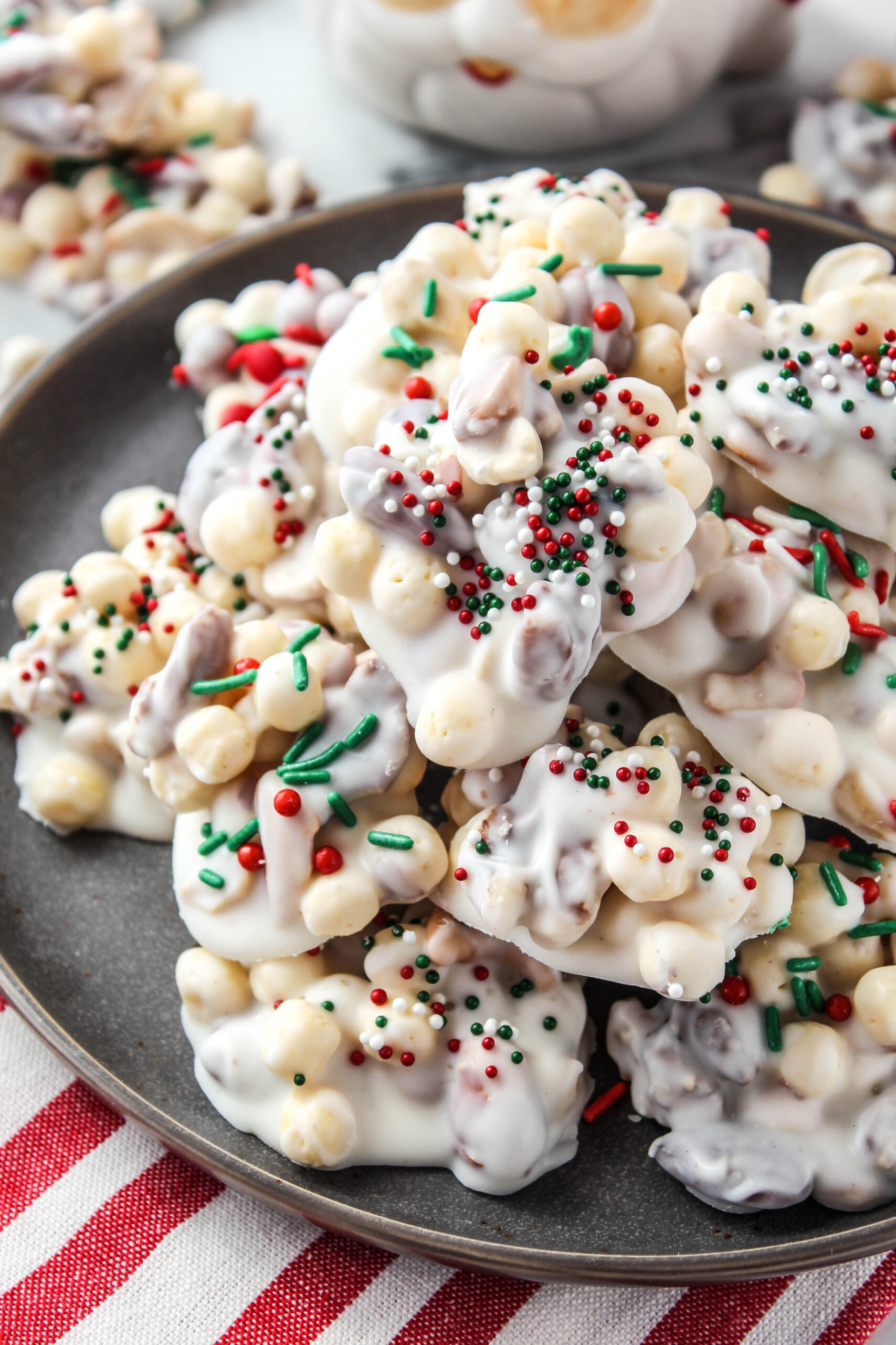 Almond bark clusters displayed with holiday décor in the background