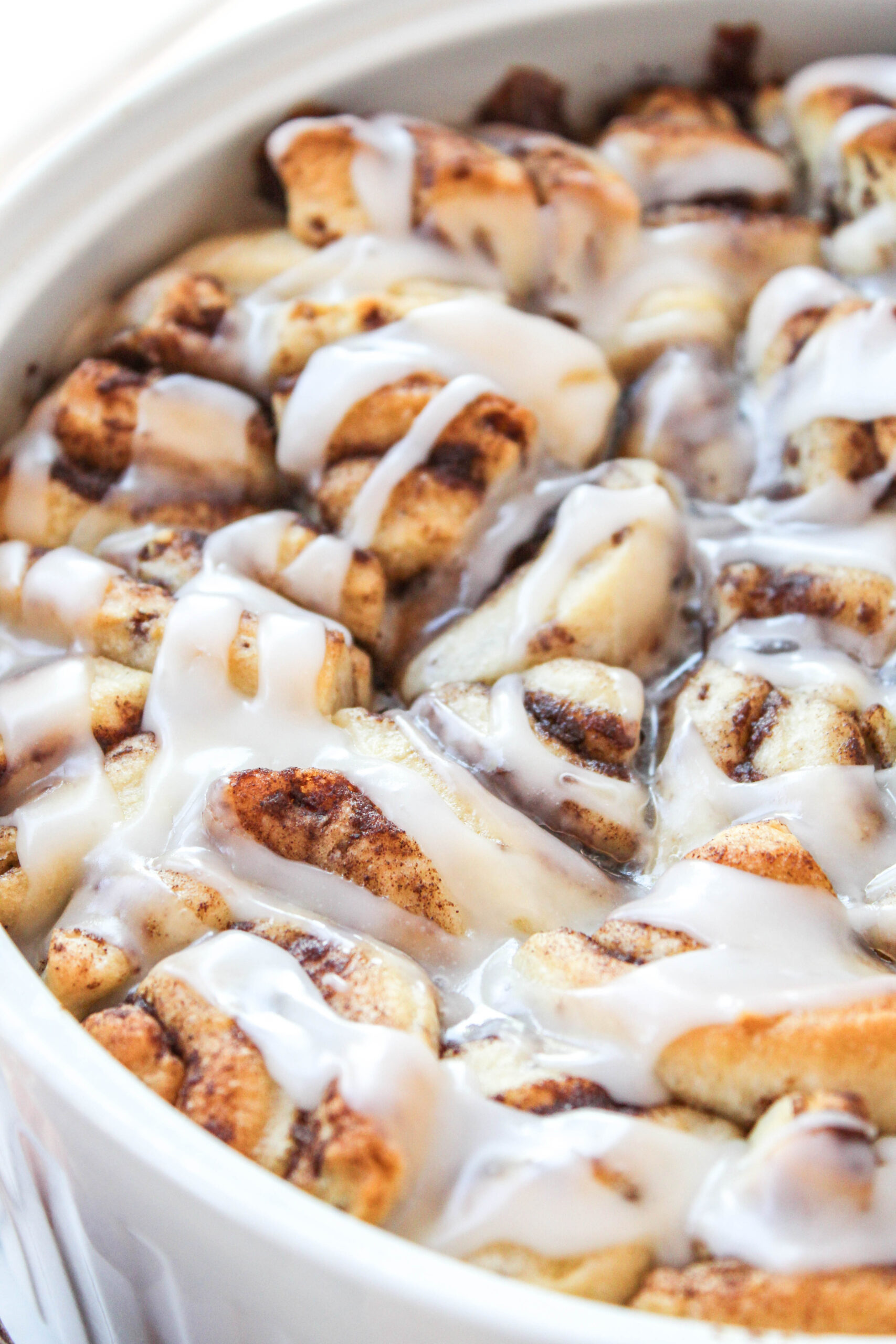 Cinnamon roll peach cobbler baked until golden brown with sweet peaches and cinnamon swirl topping