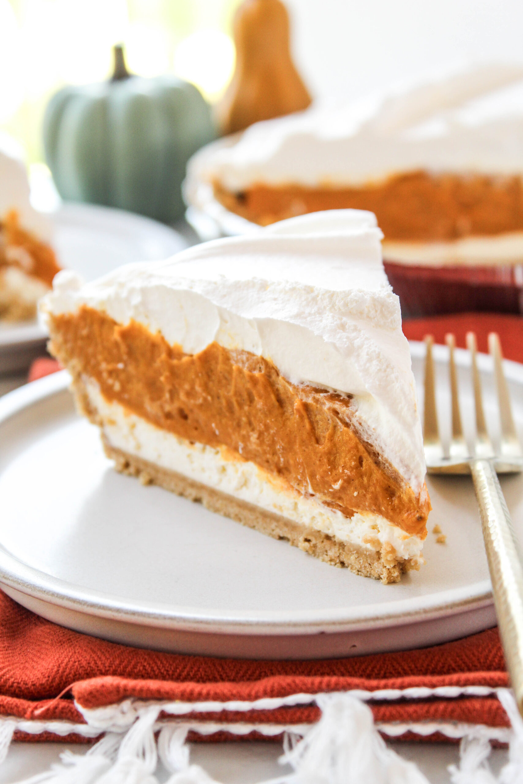 Creamy triple layer pumpkin pie with distinct layers and a graham cracker crust