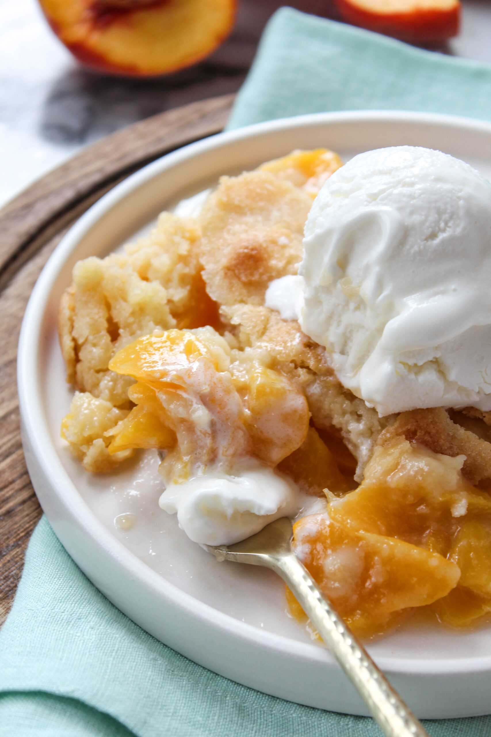 Classic peach cobbler served warm with bubbling peach filling