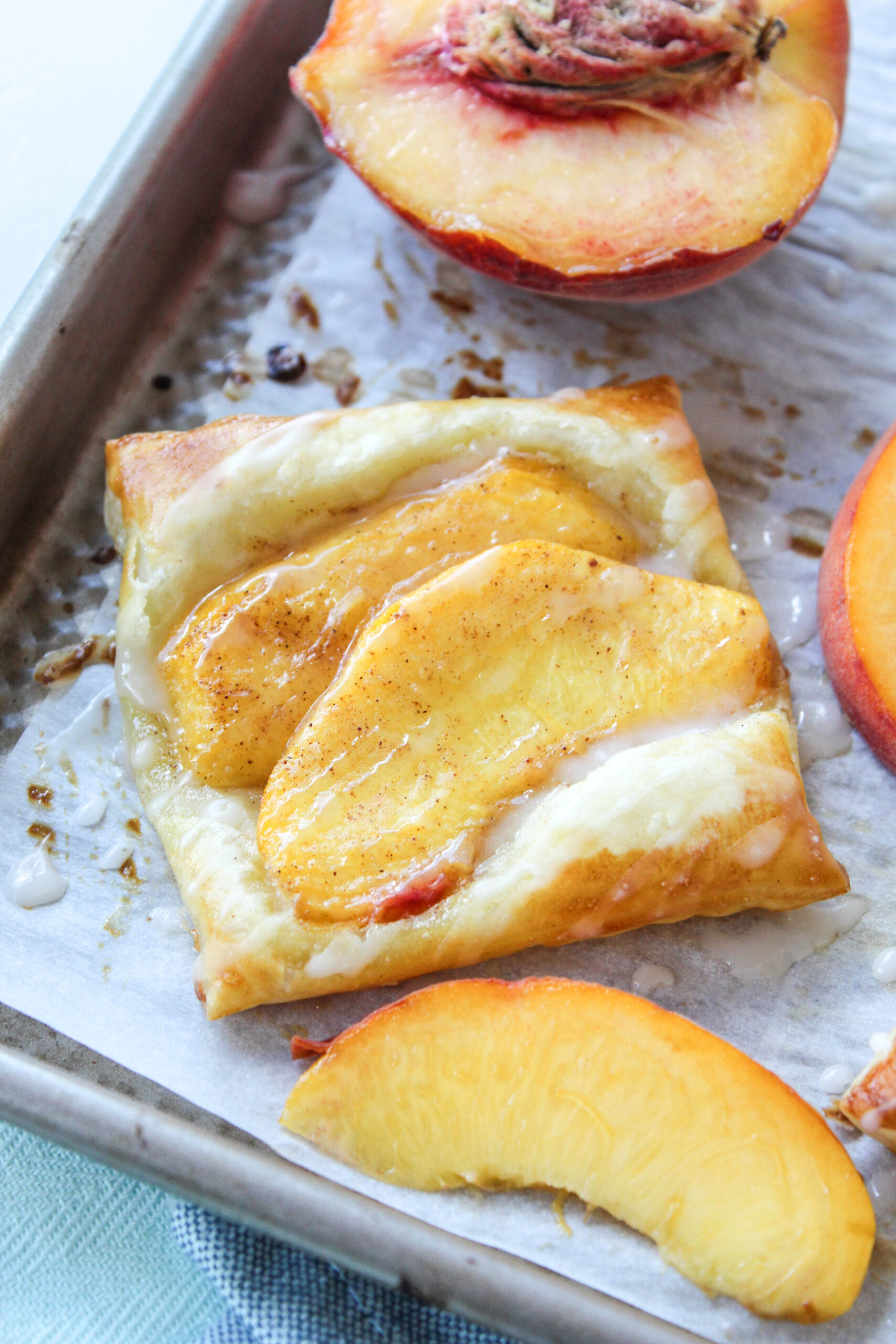 Peach puff pastry tarts made with flaky pastry and fresh sliced peaches