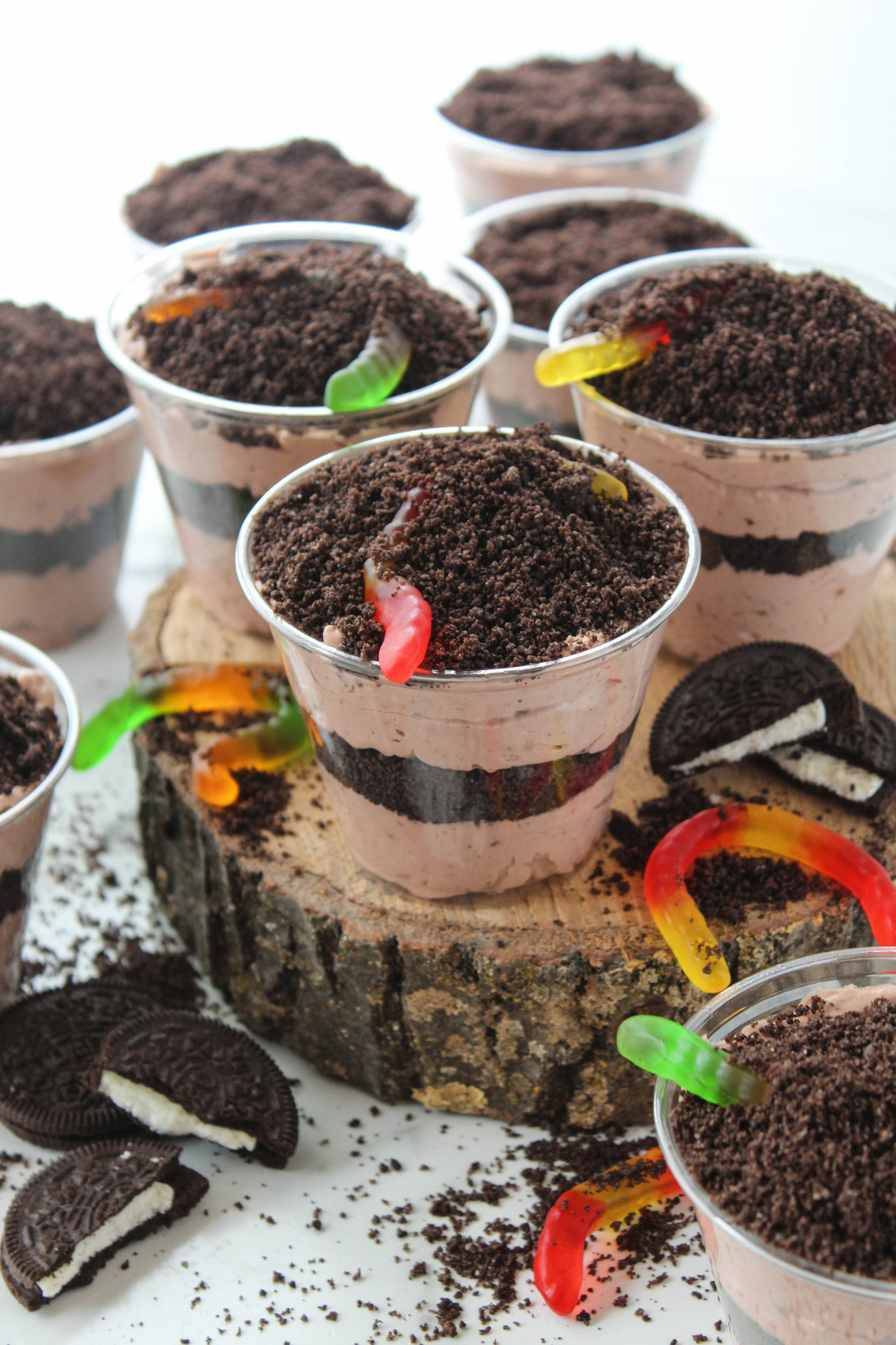 Oreo dirt cake cups made with chocolate pudding and crushed Oreo layers in clear cups