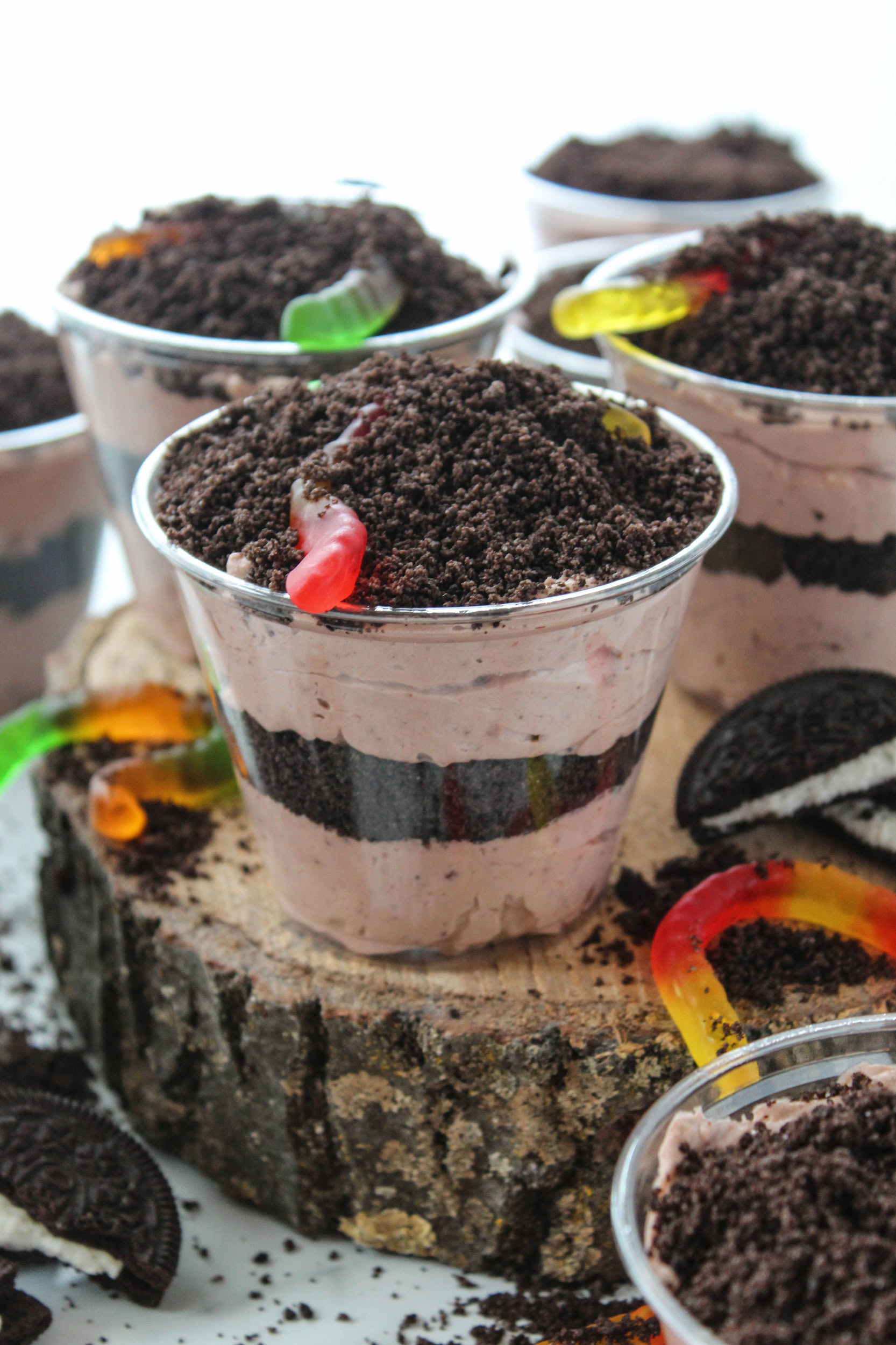 Individual Oreo dirt cake cups layered with chocolate pudding, whipped topping, and crushed Oreo cookies