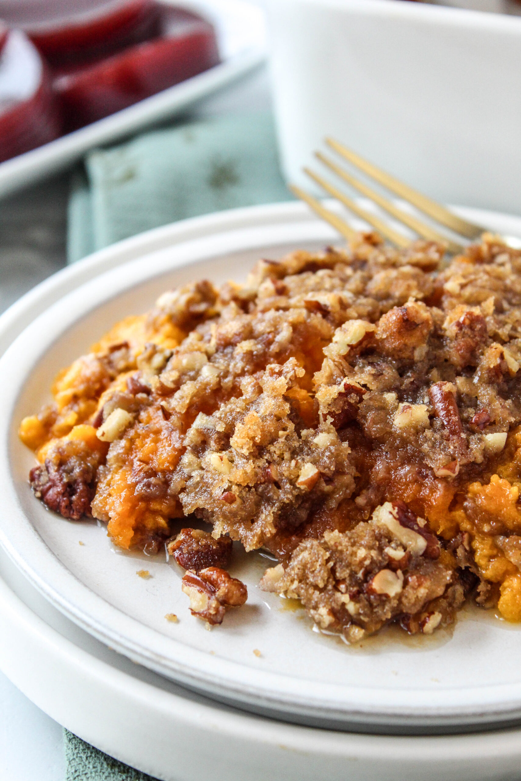 Close‑up of sweet potato casserole showing buttery praline topping