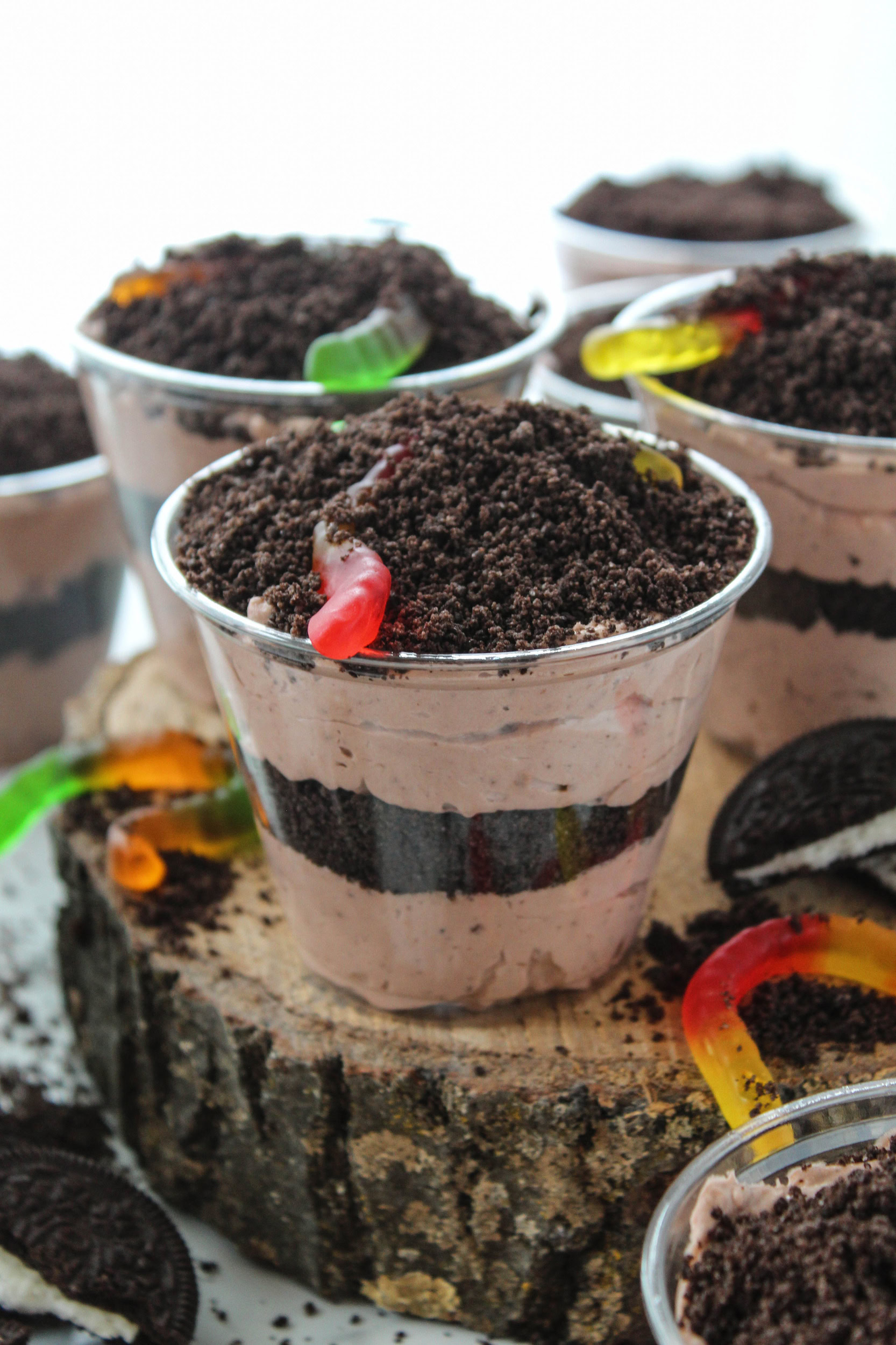 Oreo dirt cake cups topped with crushed cookies and gummy worms