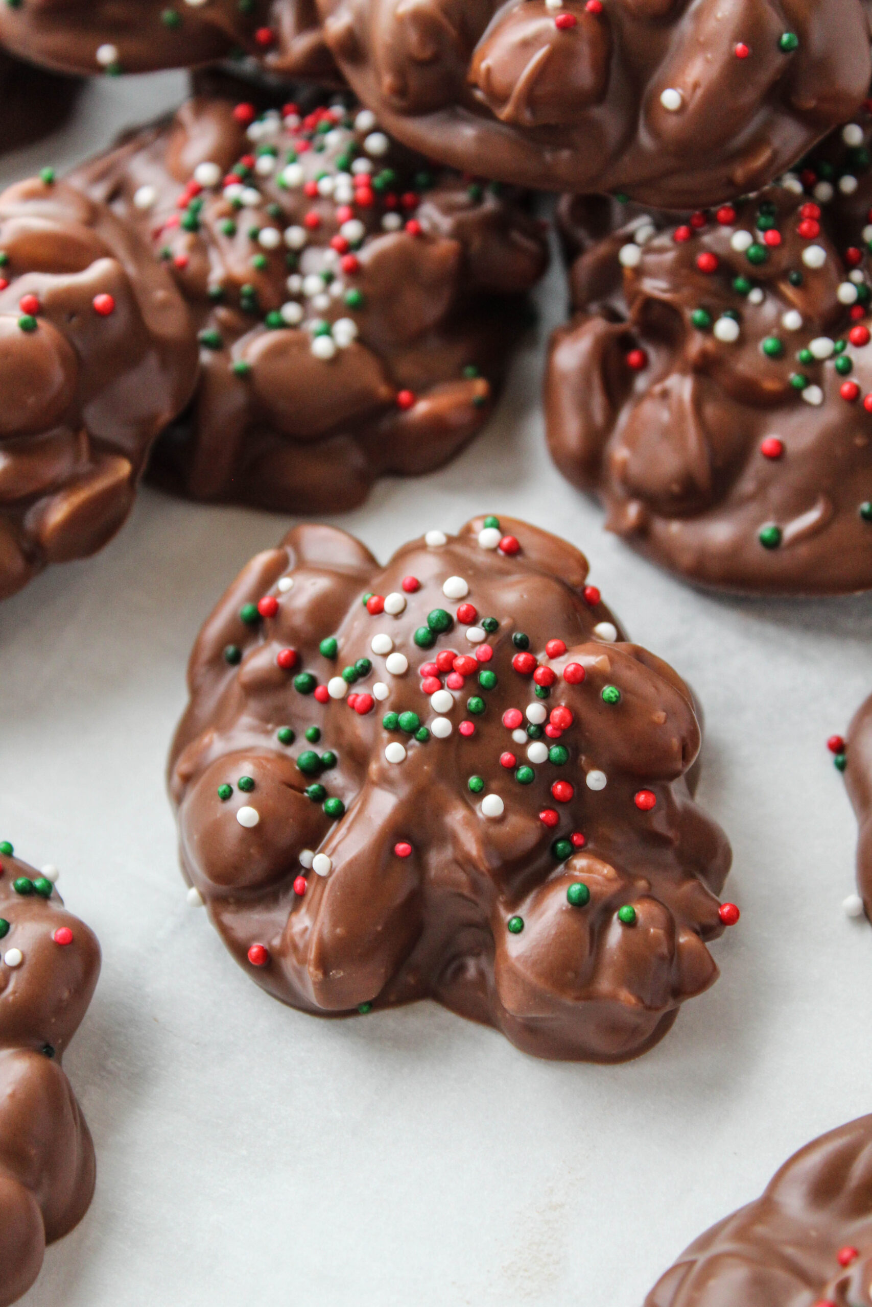Homemade crock pot Christmas crack cooling on parchment paper
