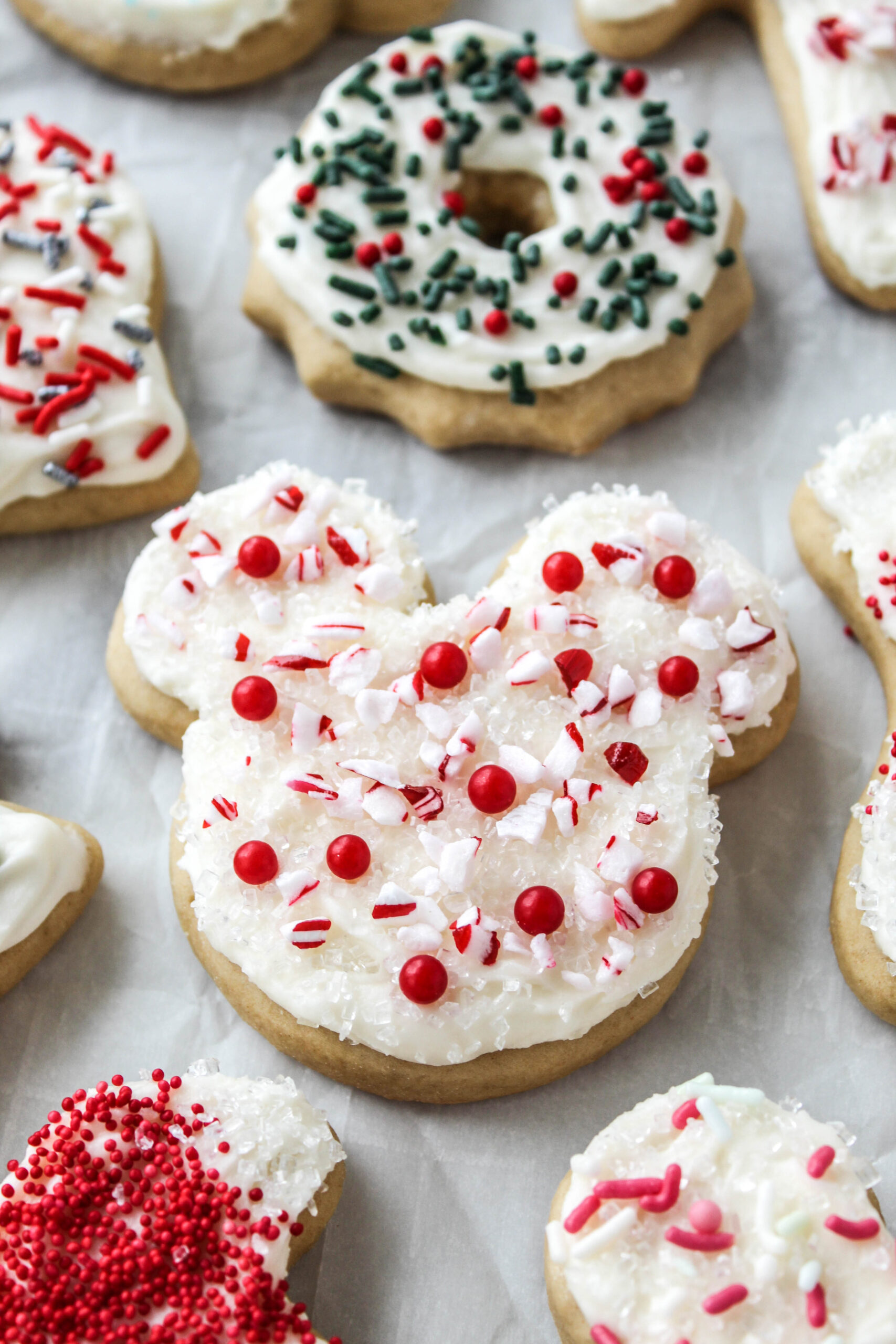 Thick Christmas sugar cookies with creamy frosting and cozy holiday decorations