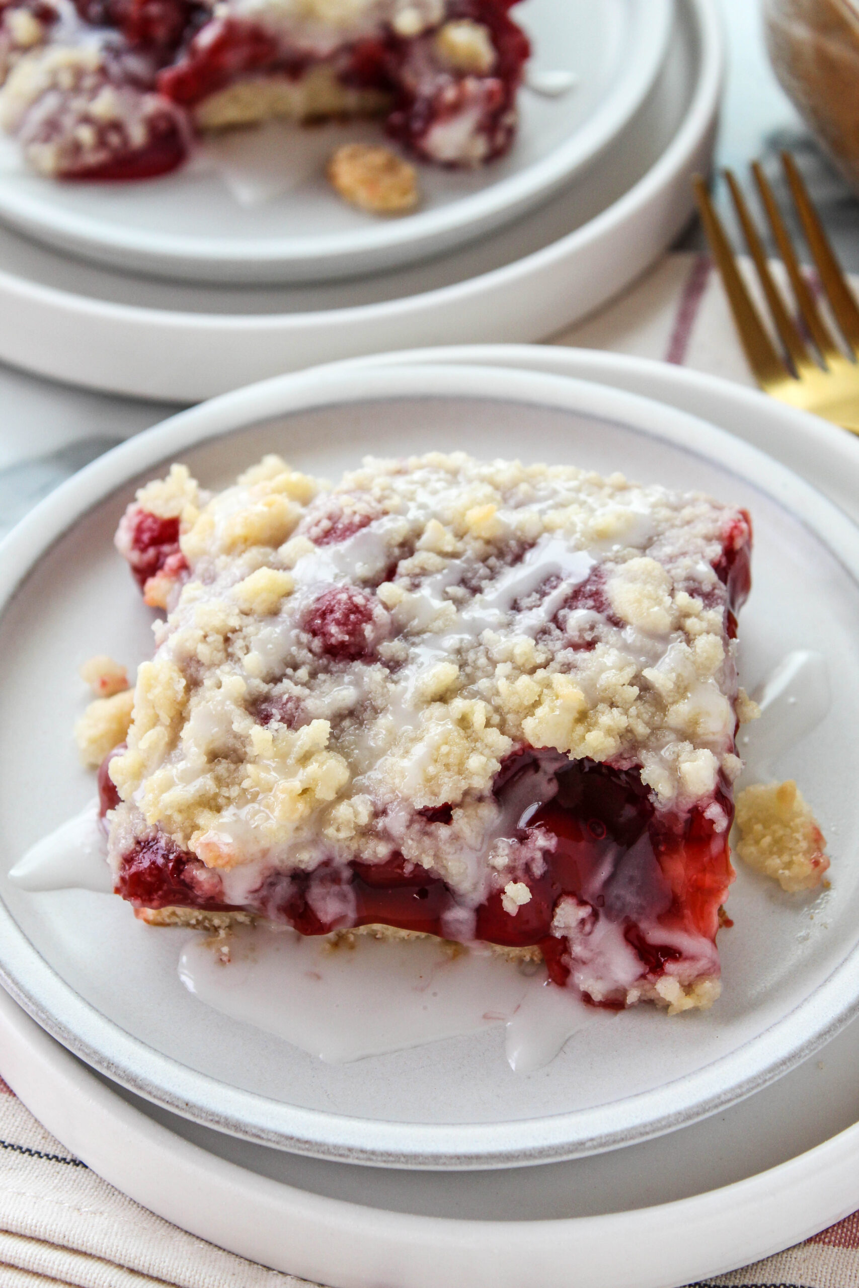 Easy cherry coffee cake sliced and served on a white dessert plate