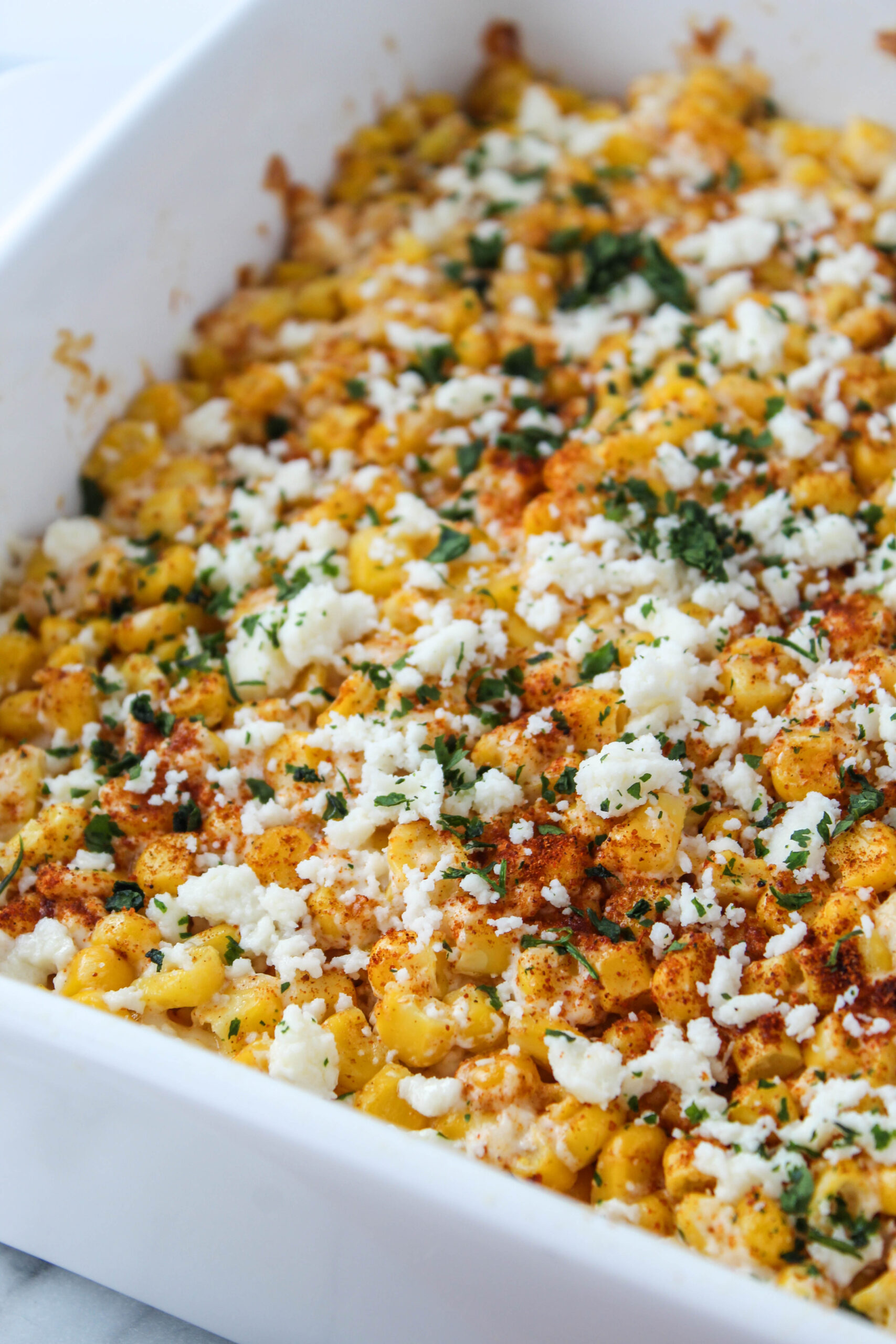 Mexican street corn casserole with cheese and cilantro