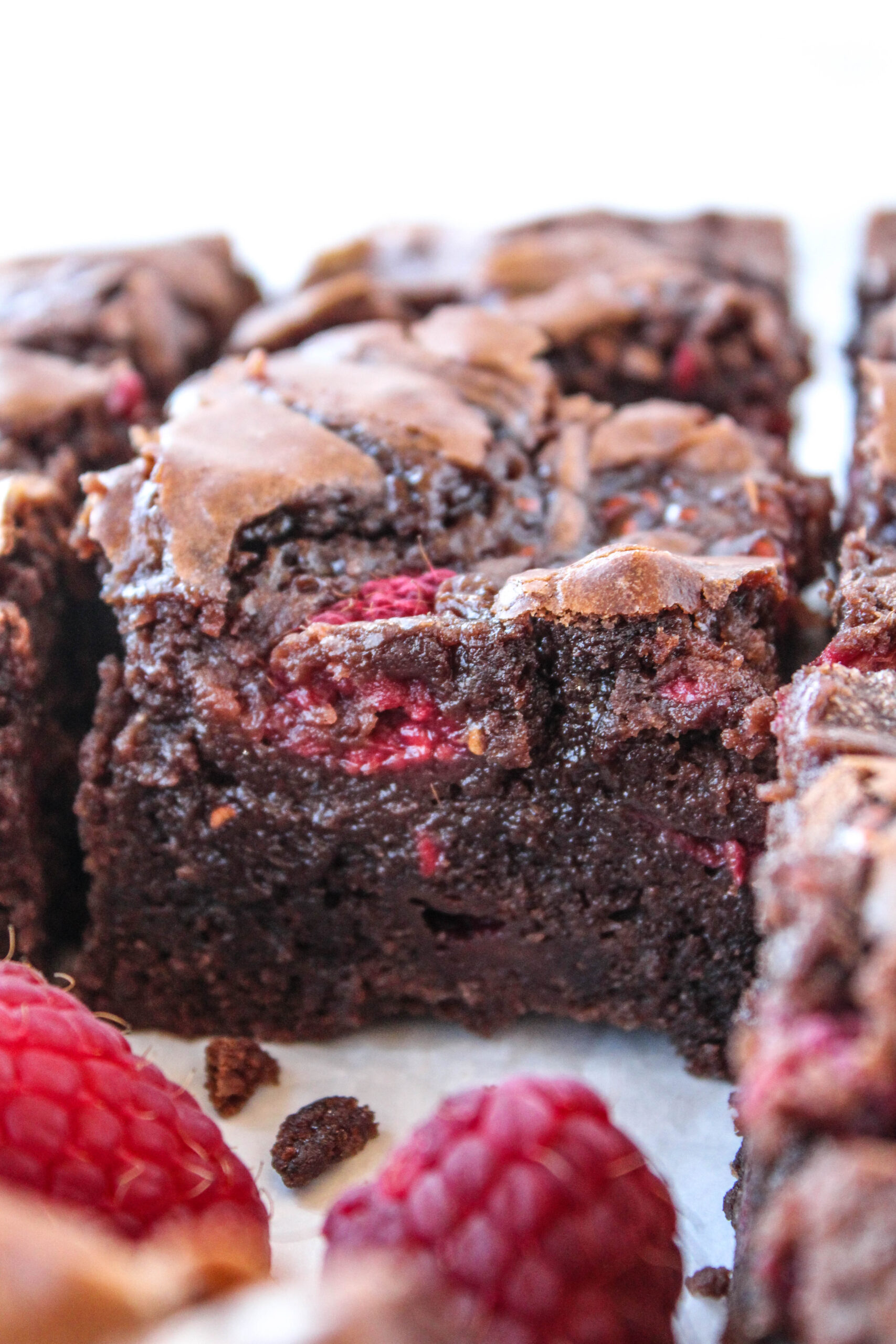 Raspberry brownie showing moist crumb and berry pieces
