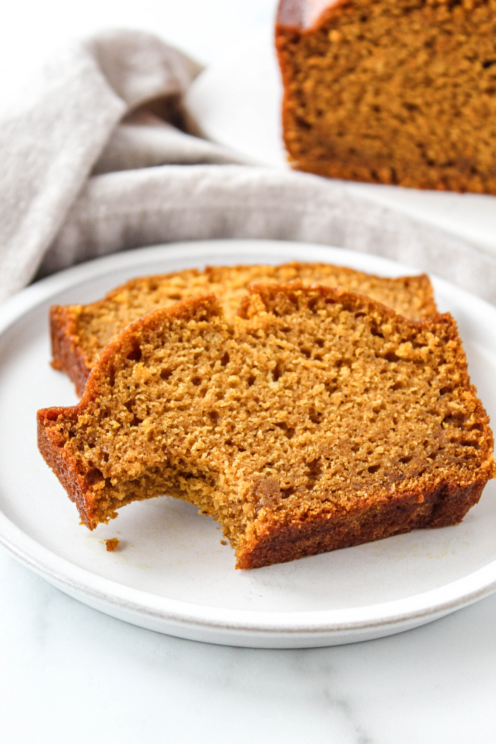Moist pumpkin bread loaf sliced to show its fluffy texture