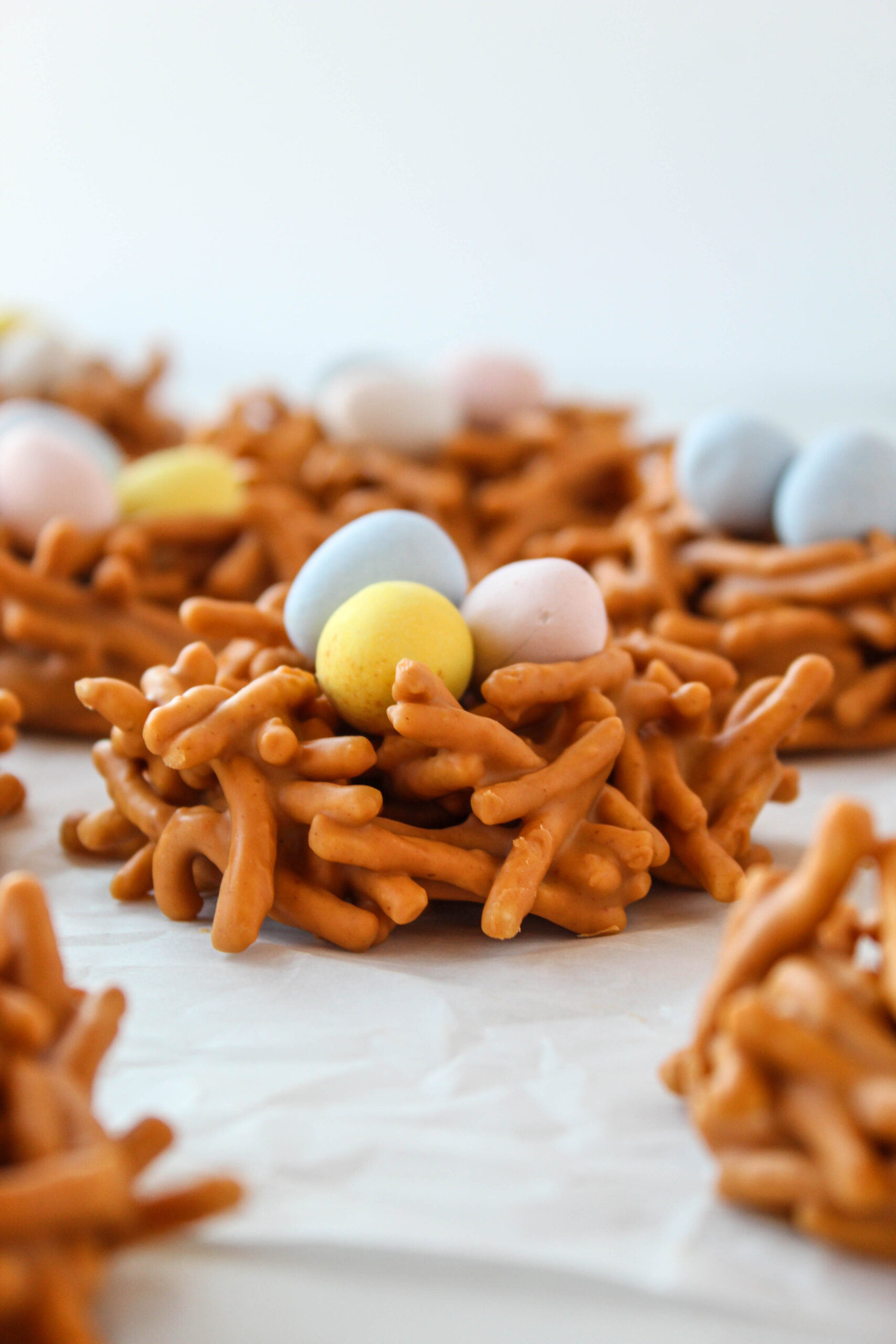 Easter bird nest cookies with butterscotch, peanut butter, crunchy noodles, and pastel chocolate eggs.