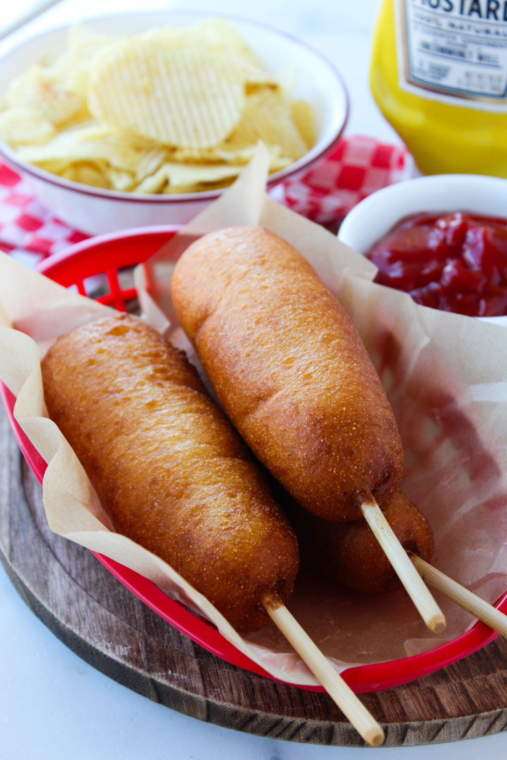 Homemade vegetarian corn dogs with crispy golden cornmeal coating on wooden skewers