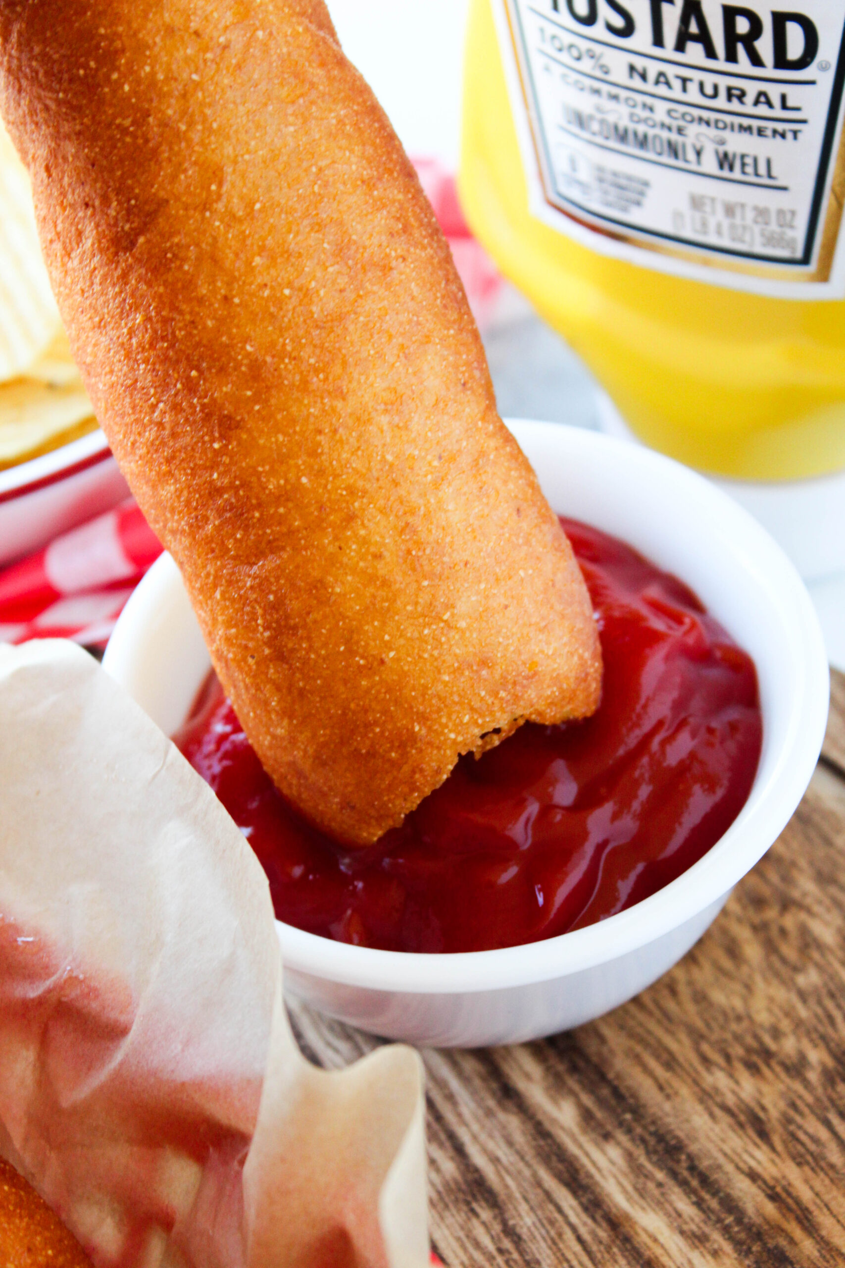 Close-up of crispy vegetarian corn dogs with dipping sauces