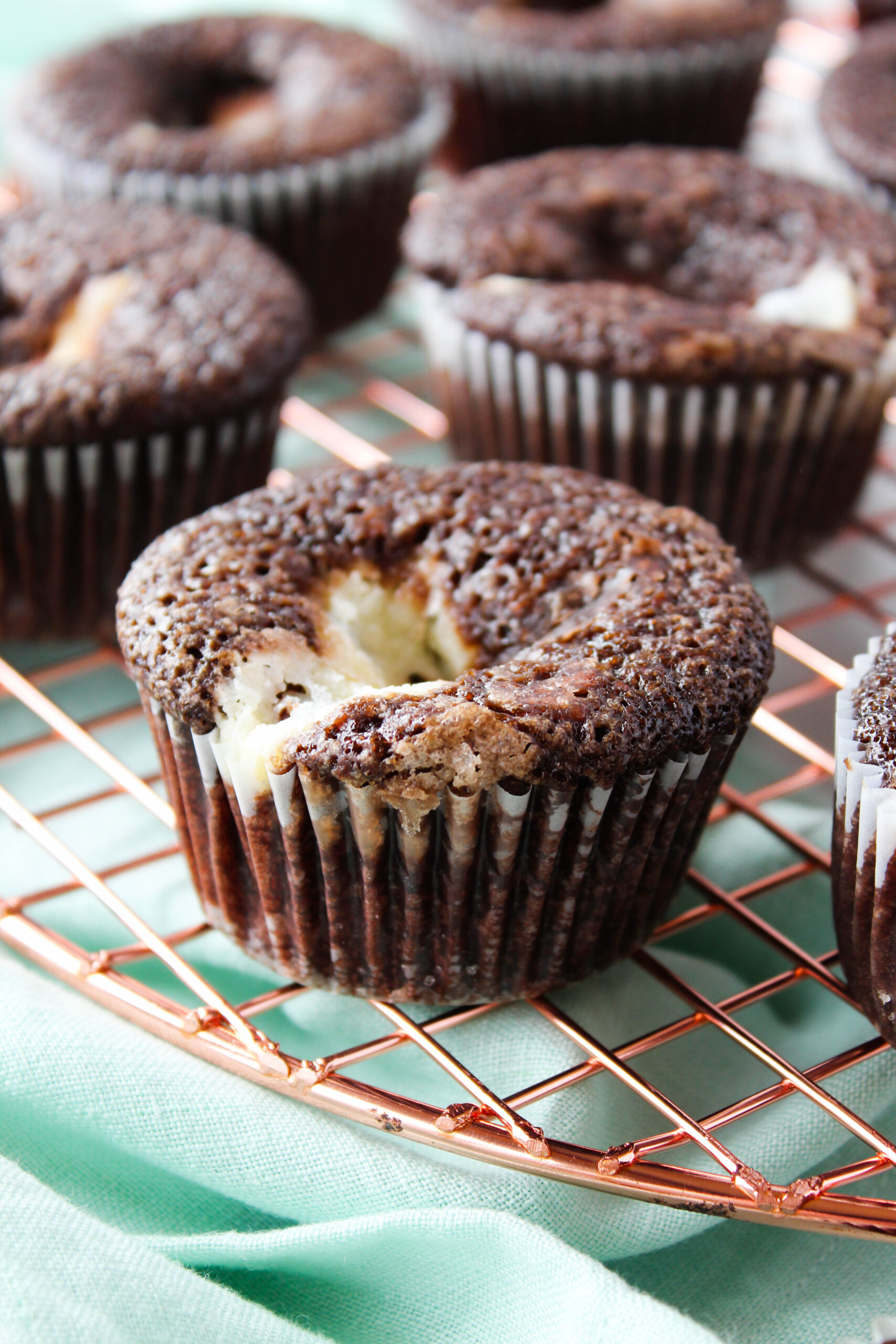 Chocolate black bottom cupcakes cooling on a wire rack