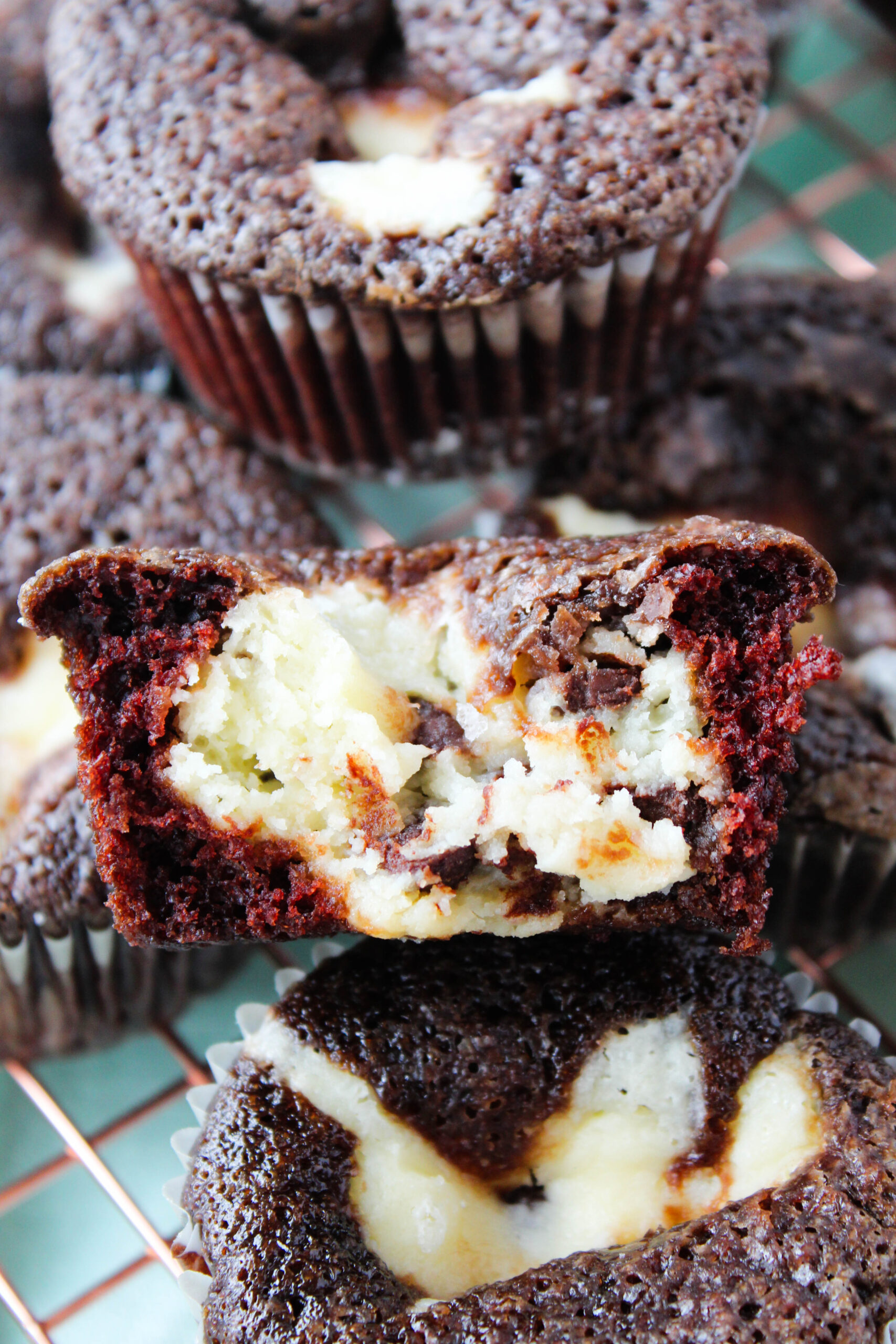 Close-up of a black bottom cupcake showing creamy cheesecake filling