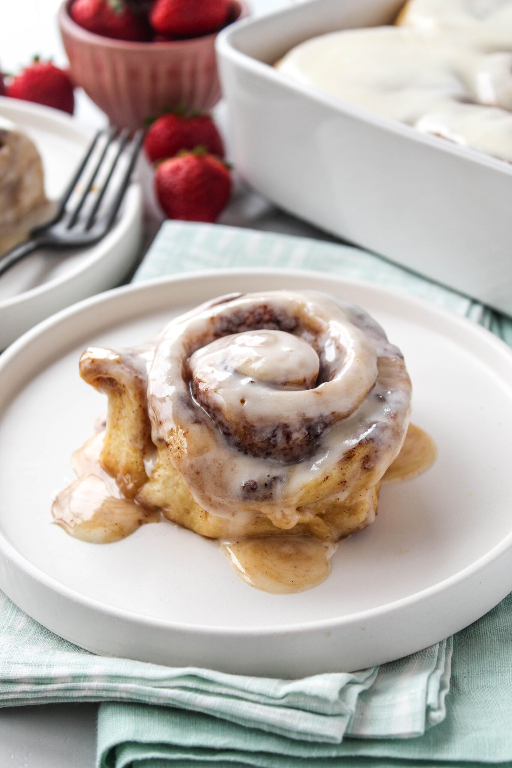 Close‑up of soft, gooey TikTok cinnamon rolls with melted icing